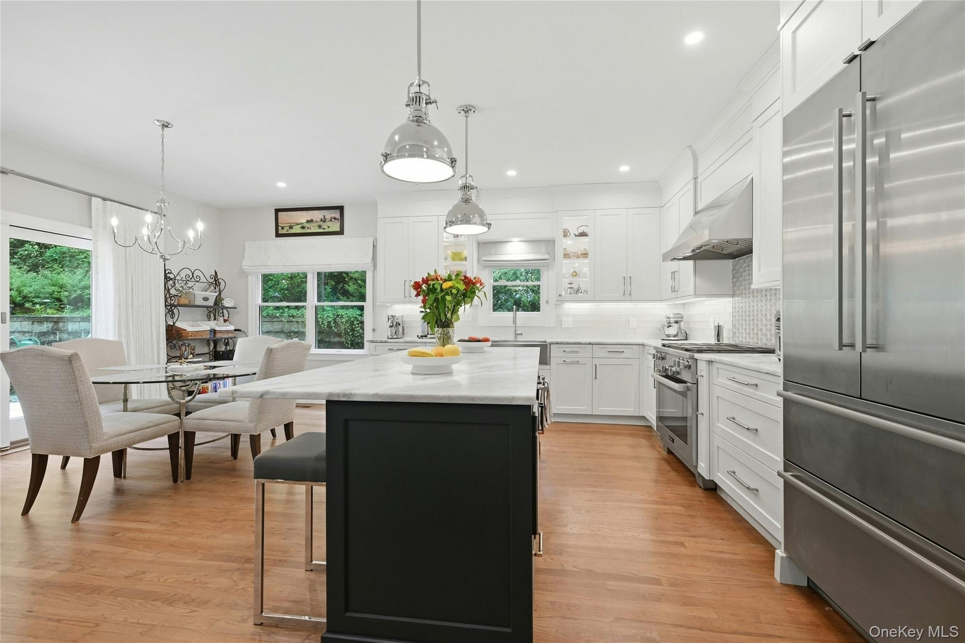 Chef's kitchen with new SS appliances and pendant lighting