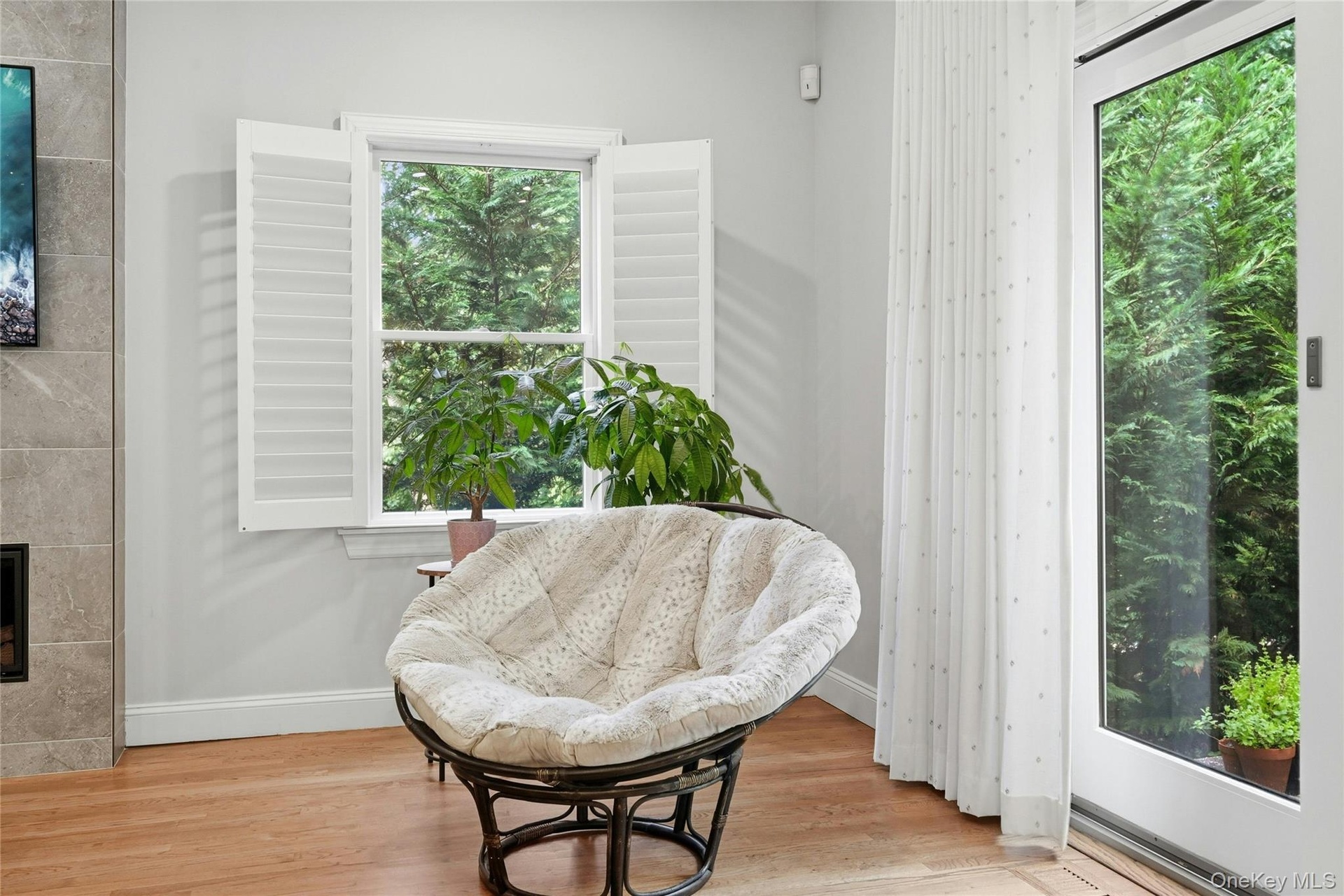 Delightful reading corner near patio sliders, custom plantation shutters