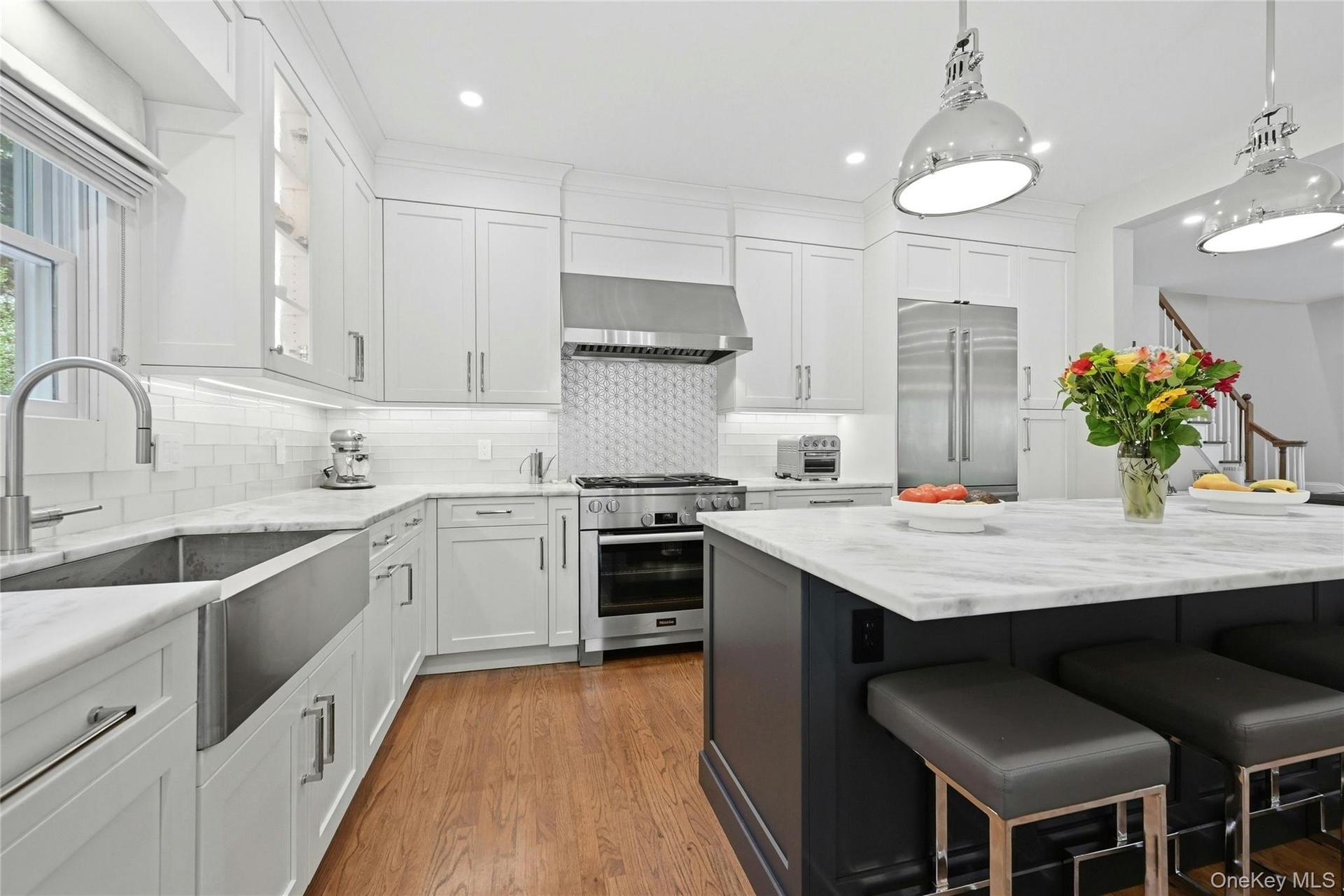 Leathered quartzite counters and custom Maple cabinets with polished nickel handles