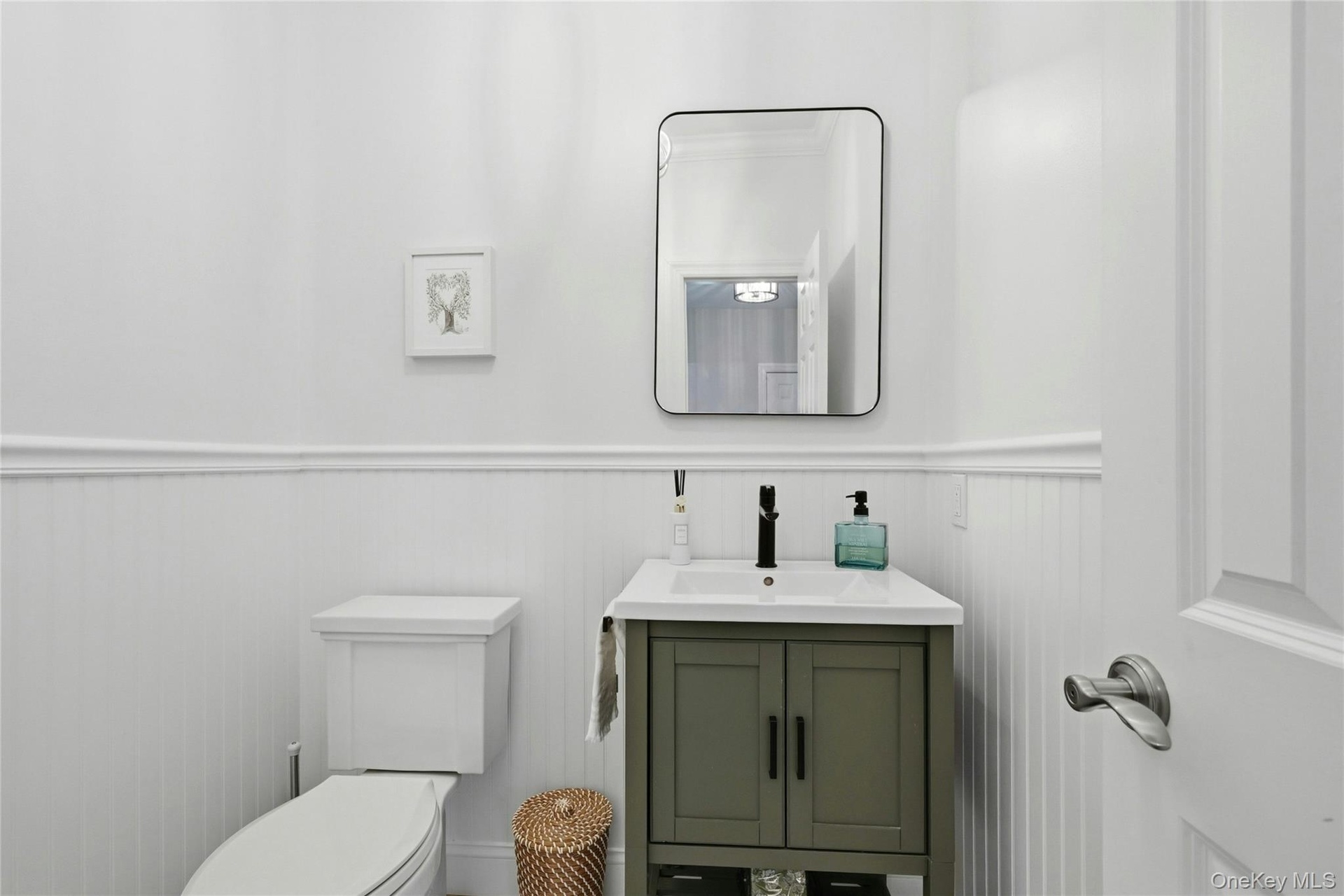 Main floor half bath with marble tile