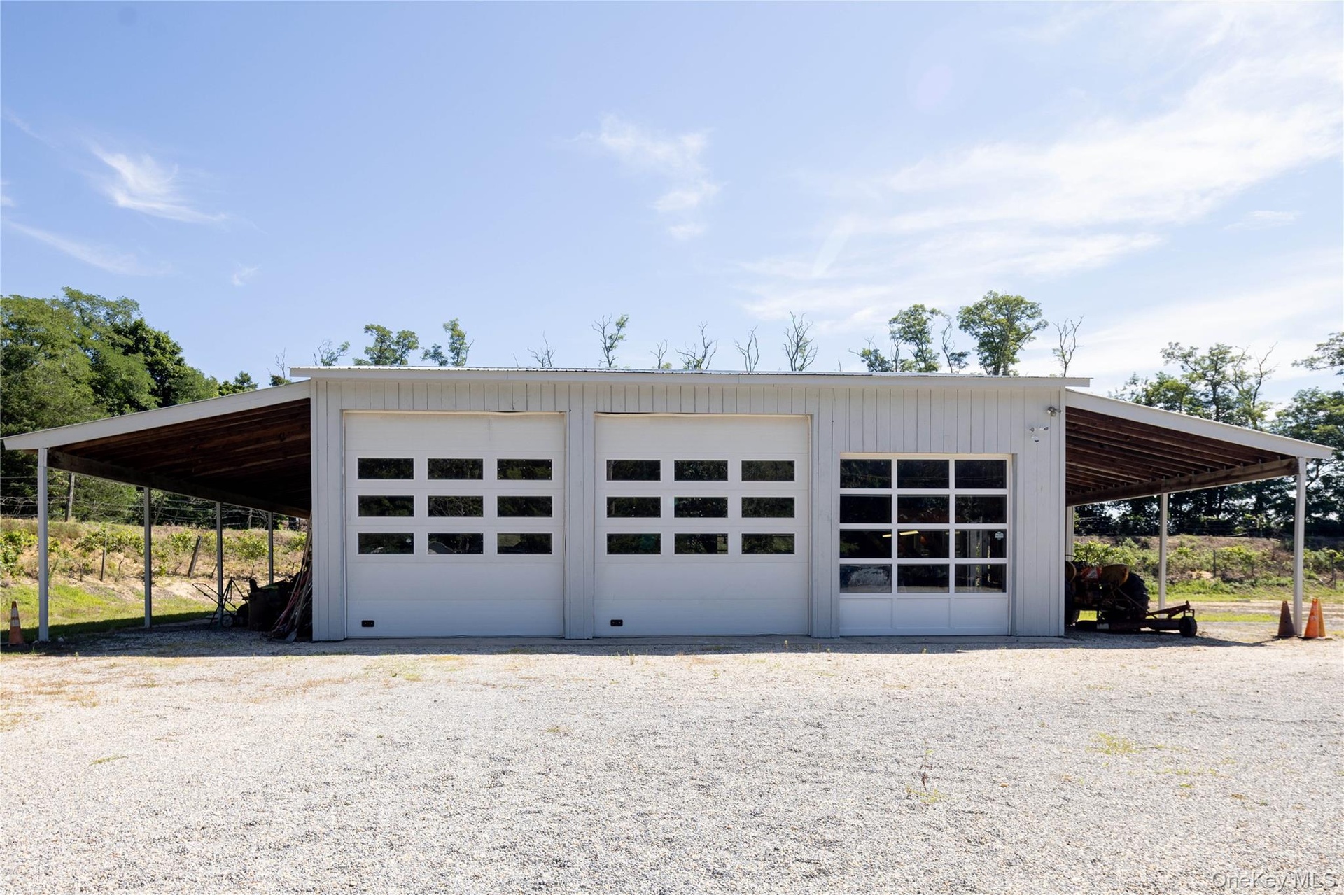 Exterior view of large garage structure with three 14' run-ins