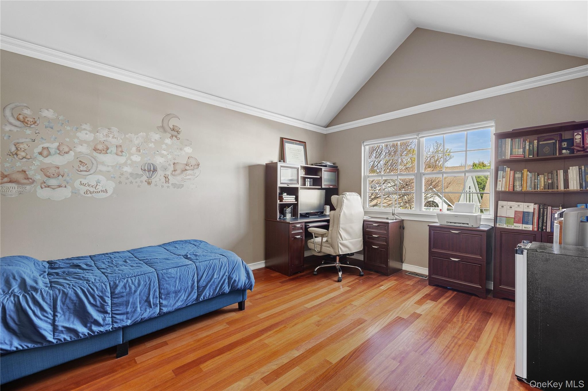 Upper Bedrm, vaulted ceiling with white crown molding, wood-finish flooring, and a large window