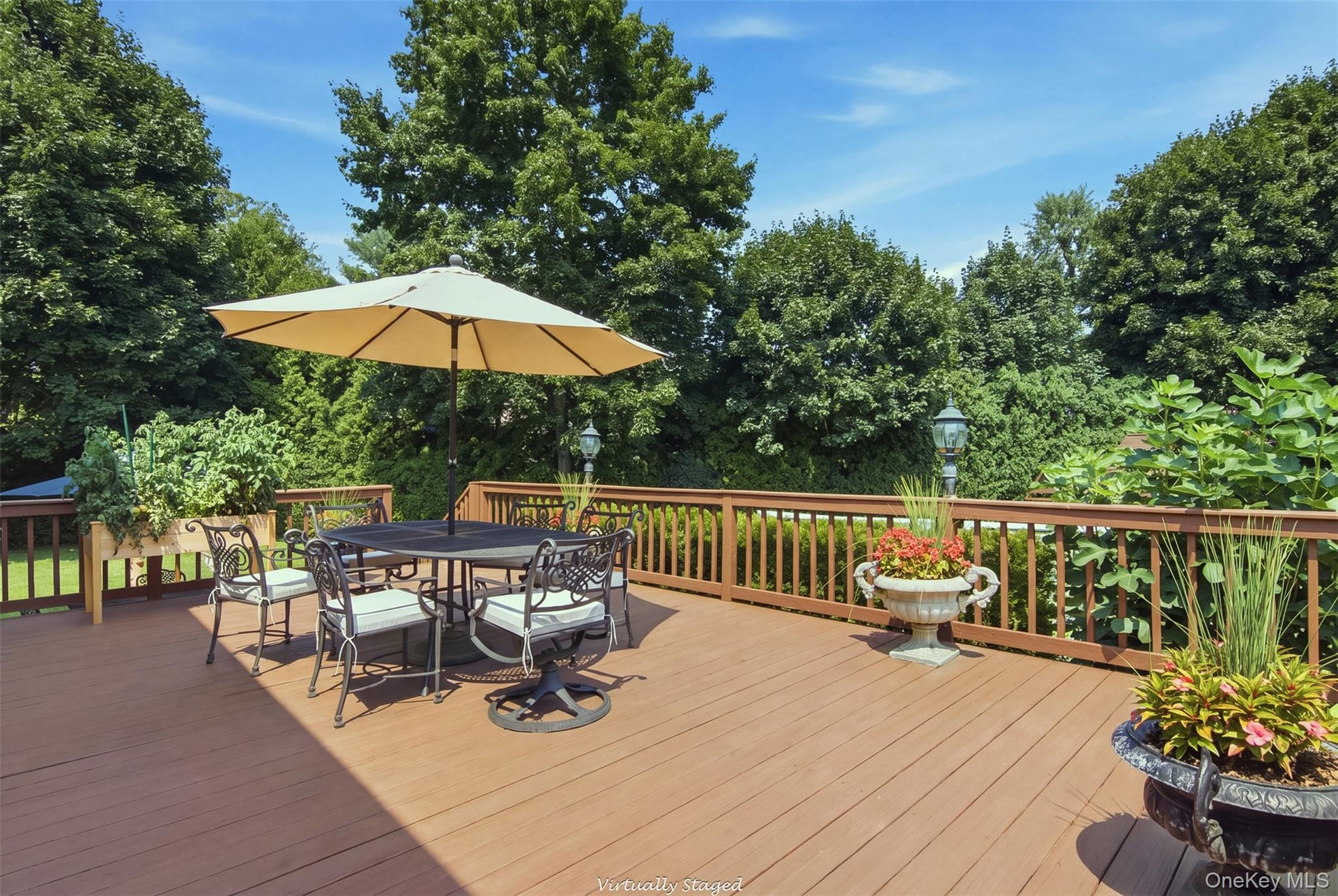 Expansive outdoor deck with a brown wood-finish surface, complete with a surrounding railing