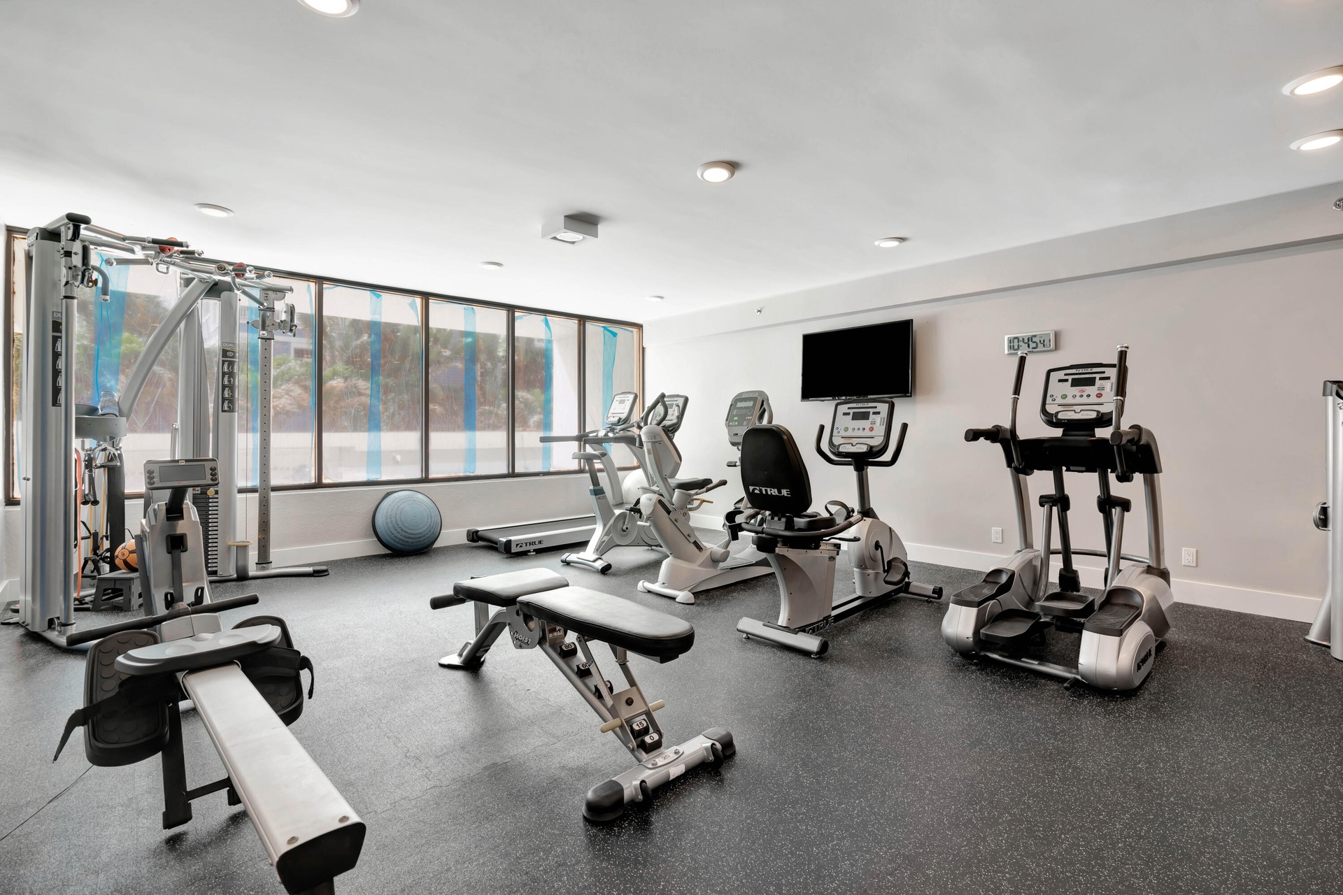 Fully equipped fitness center featuring cardio and strength-traininng equipment, offering everything you need to stay active without leaving home