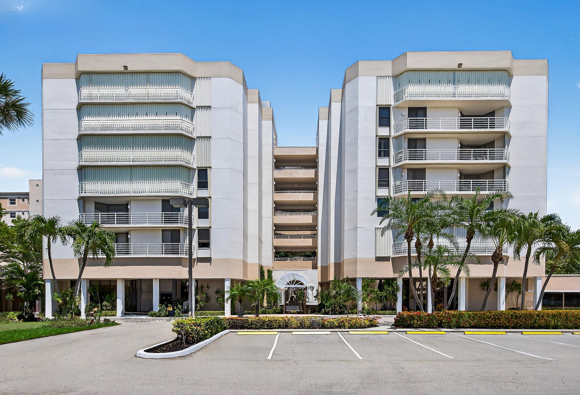 Exterior view showcasing the distinctive architecture of this oceanfront Jupiter community