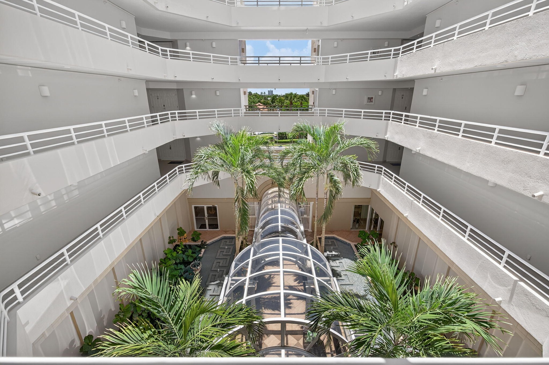 Stunning open-air atrium, bringing natural light and tropical beauty to the heart of the building.