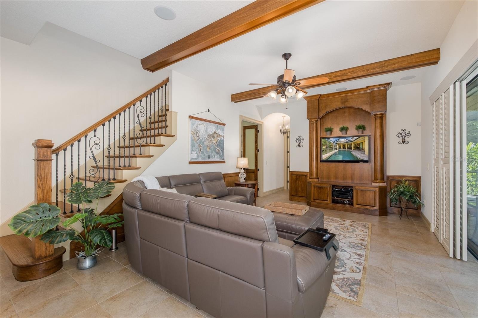 Family Room adjacent to striking staircase leading to Bonus & Media Rooms