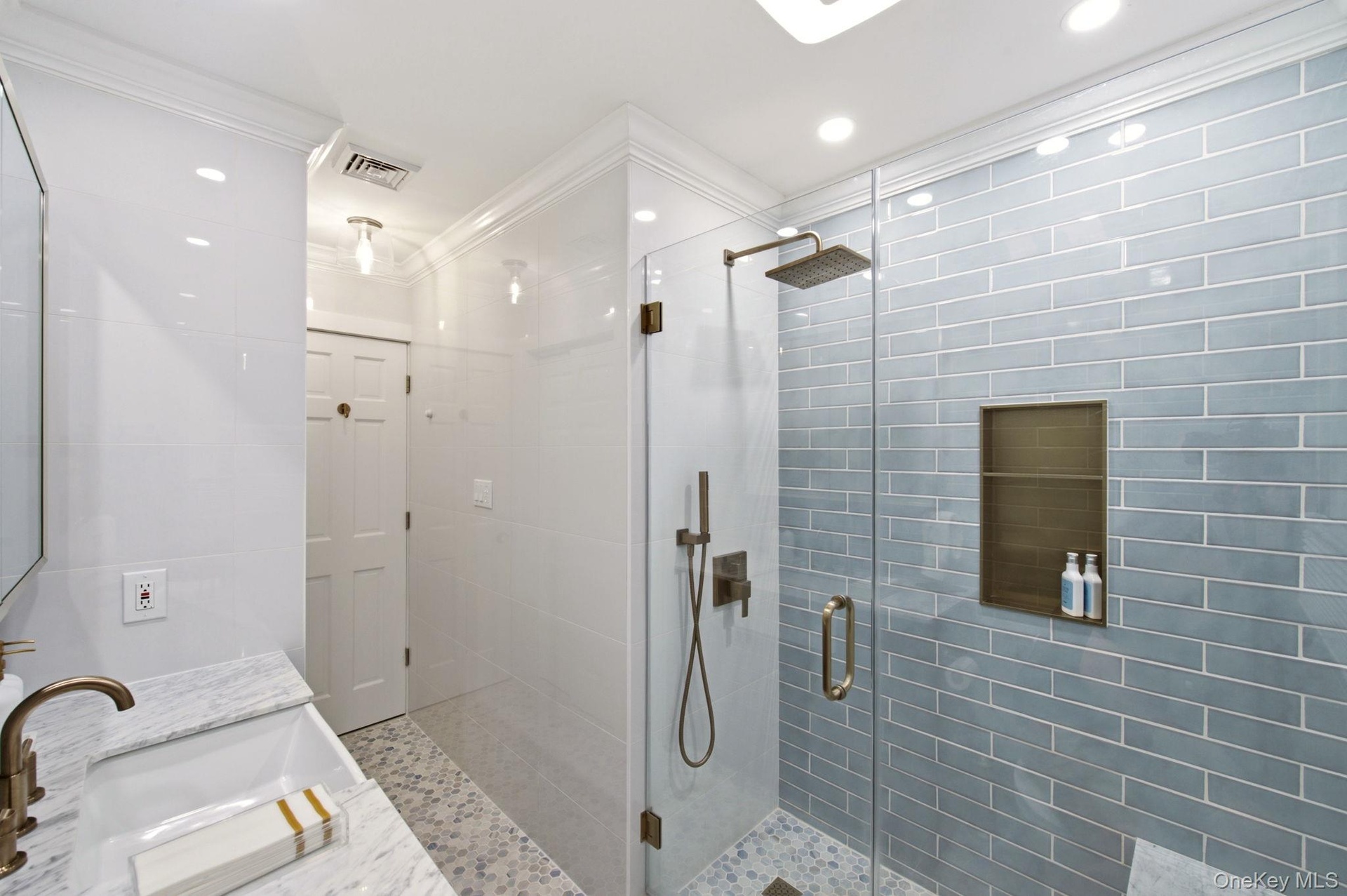 New Tile and Brass Finishes give this Bathroom an Elegant Spa Feel!