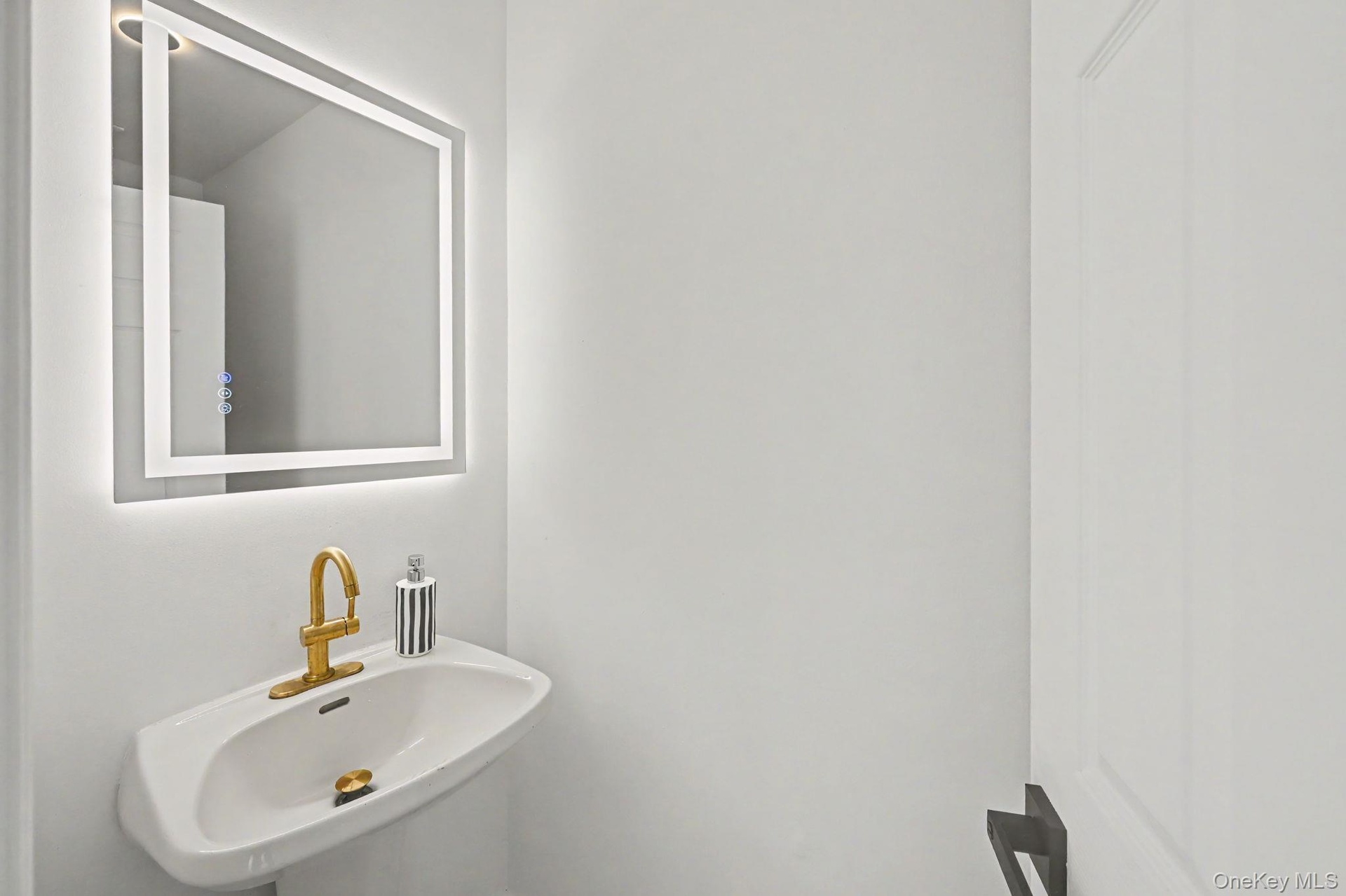 Half Bath next to entry stairs offthe kitchen