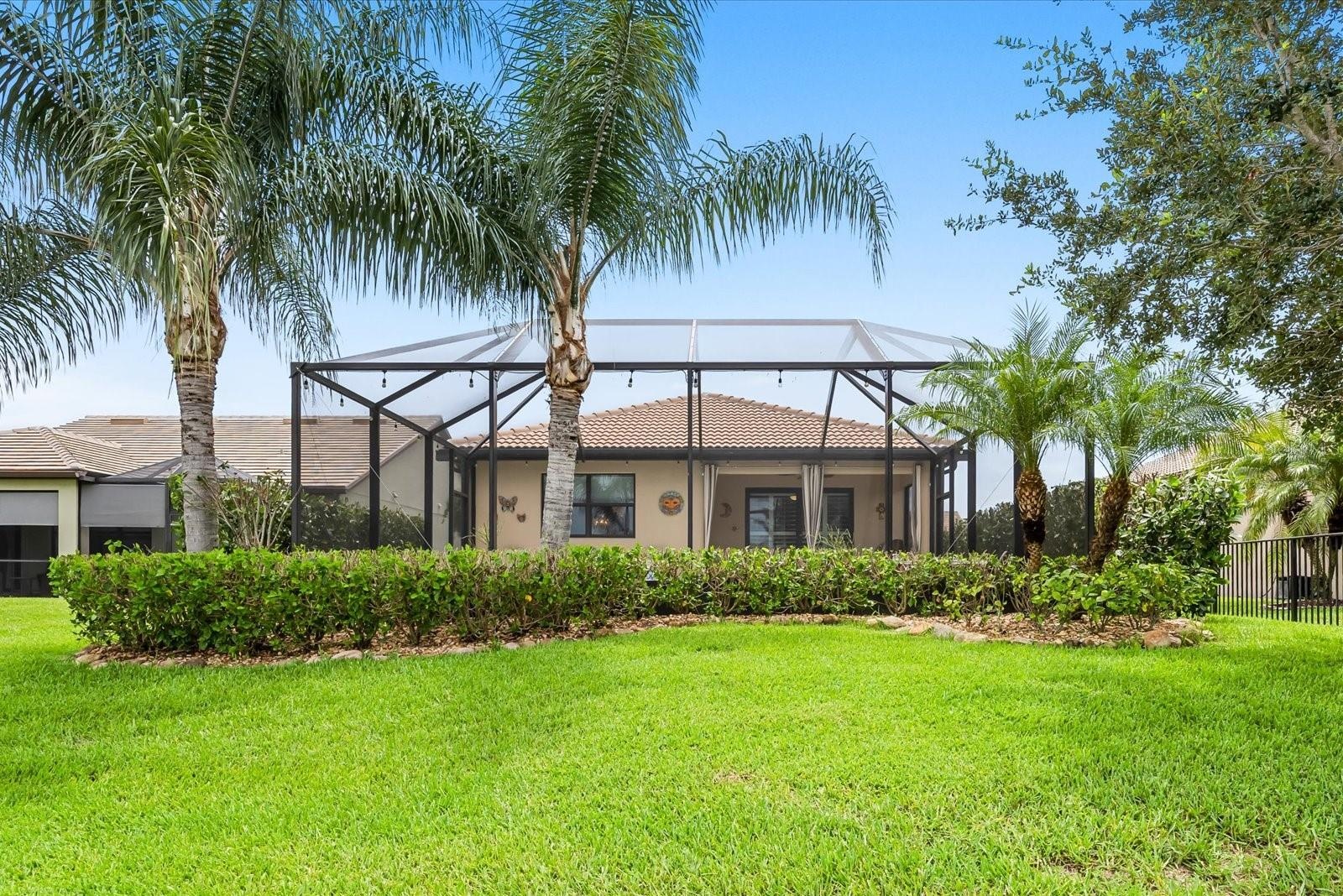 Lush, Landscaped Backyard with a Private Screened Pool