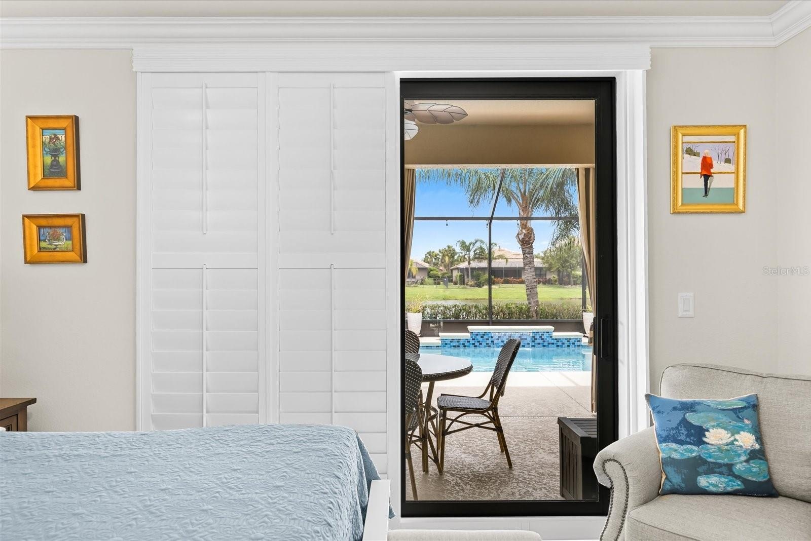 Primary Bedroom Featuring Sliding Glass Doors and Custom Shutters