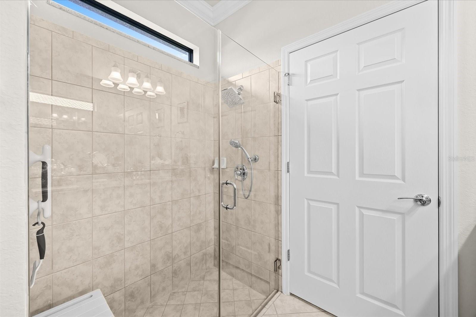 Primary Bathroom Featuring a Frameless Glass-Enclosed Shower