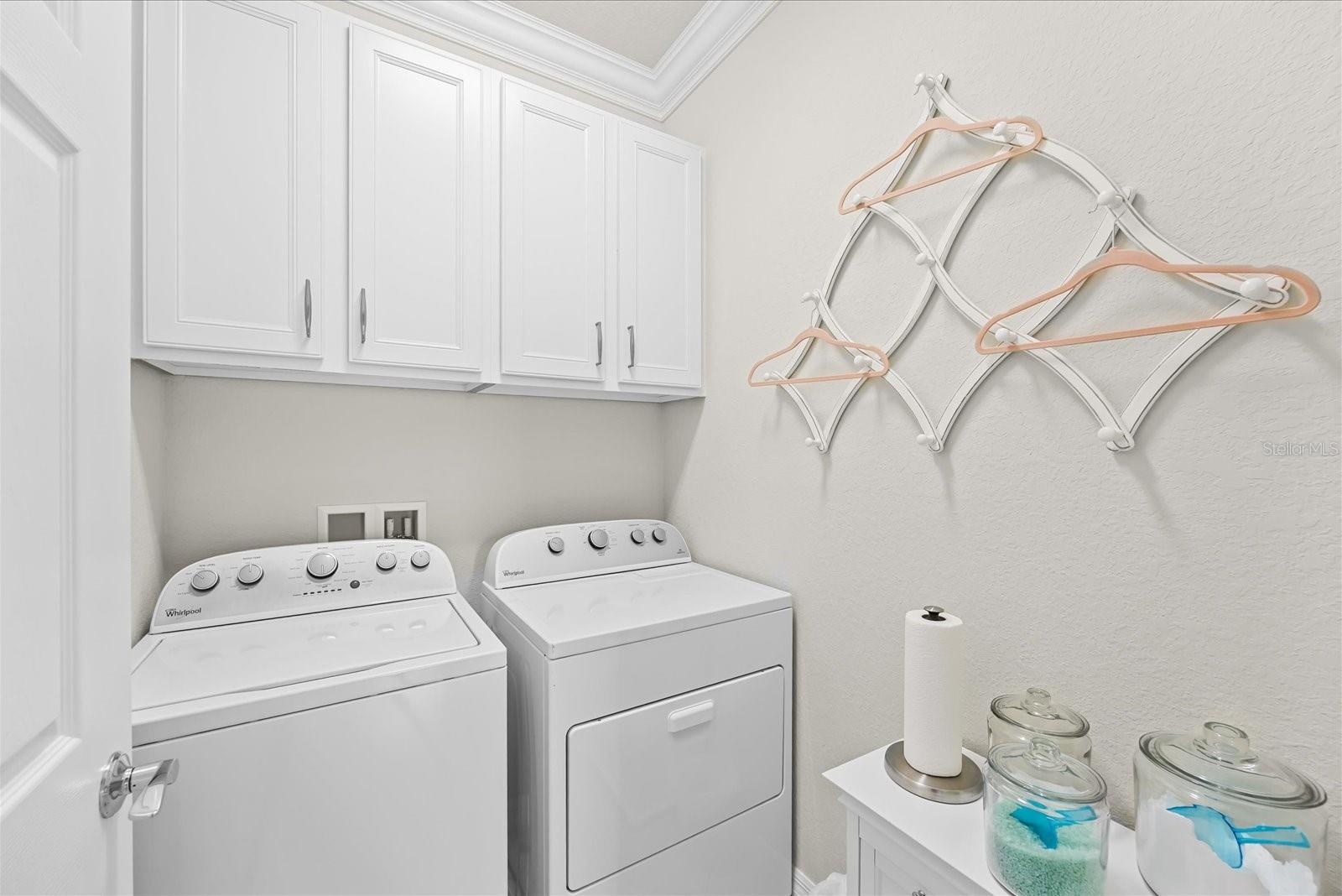 Laundry Room Featuring Built-In Cabinetry for Additional Storage