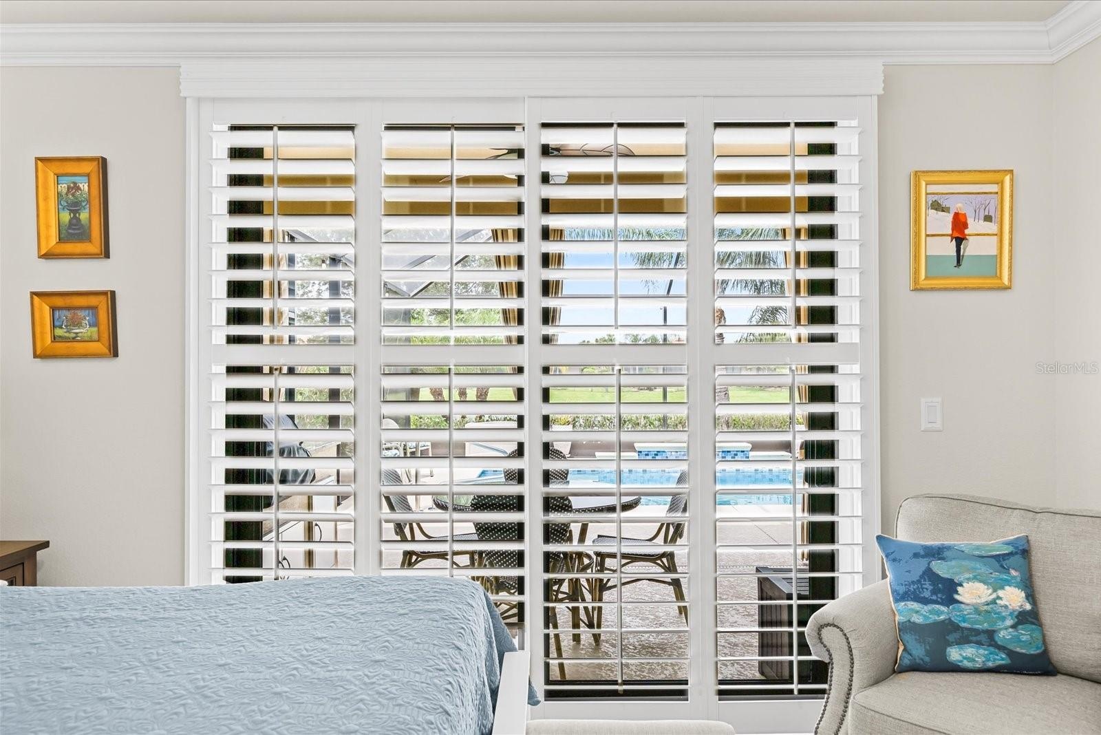 Primary Bedroom Featuring Sliding Glass Doors and Custom Shutters