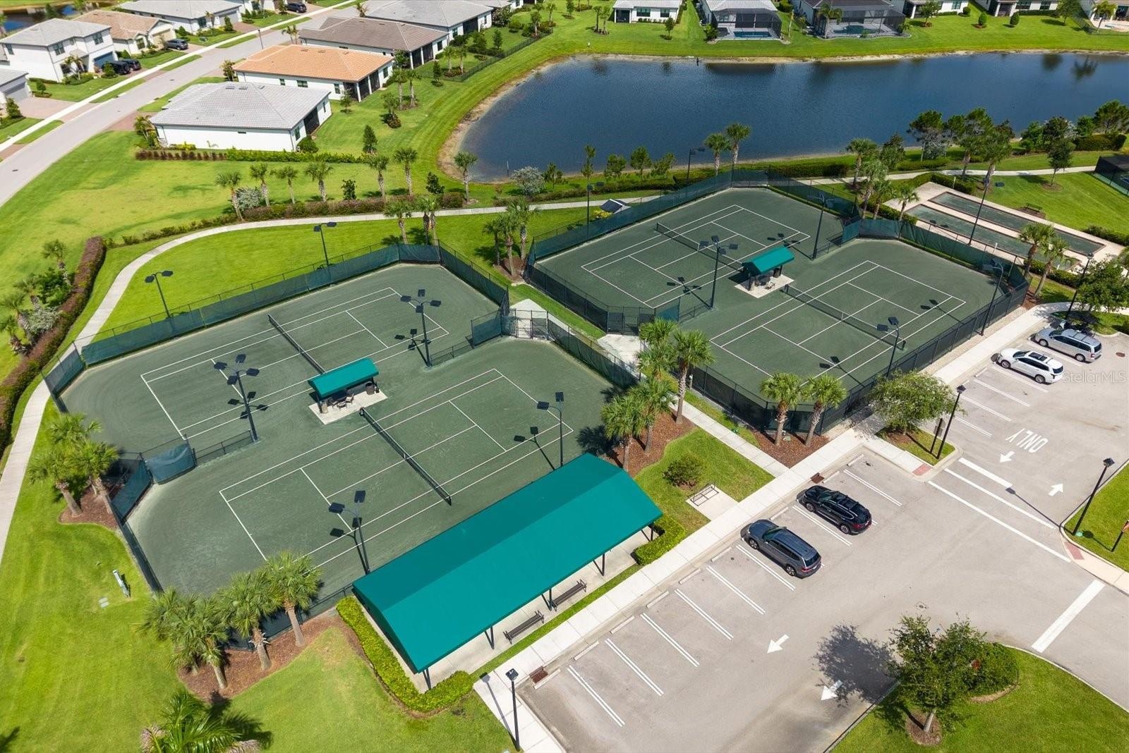 Multiple Tennis Courts Surrounded by Scenic Water Views