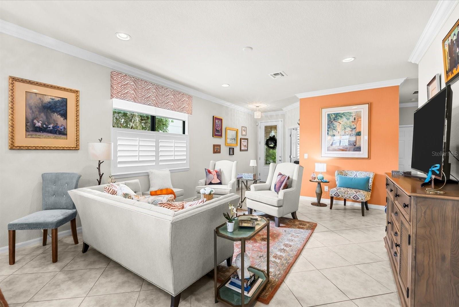 Inviting Living Space with Custom Shutters and Crown Molding