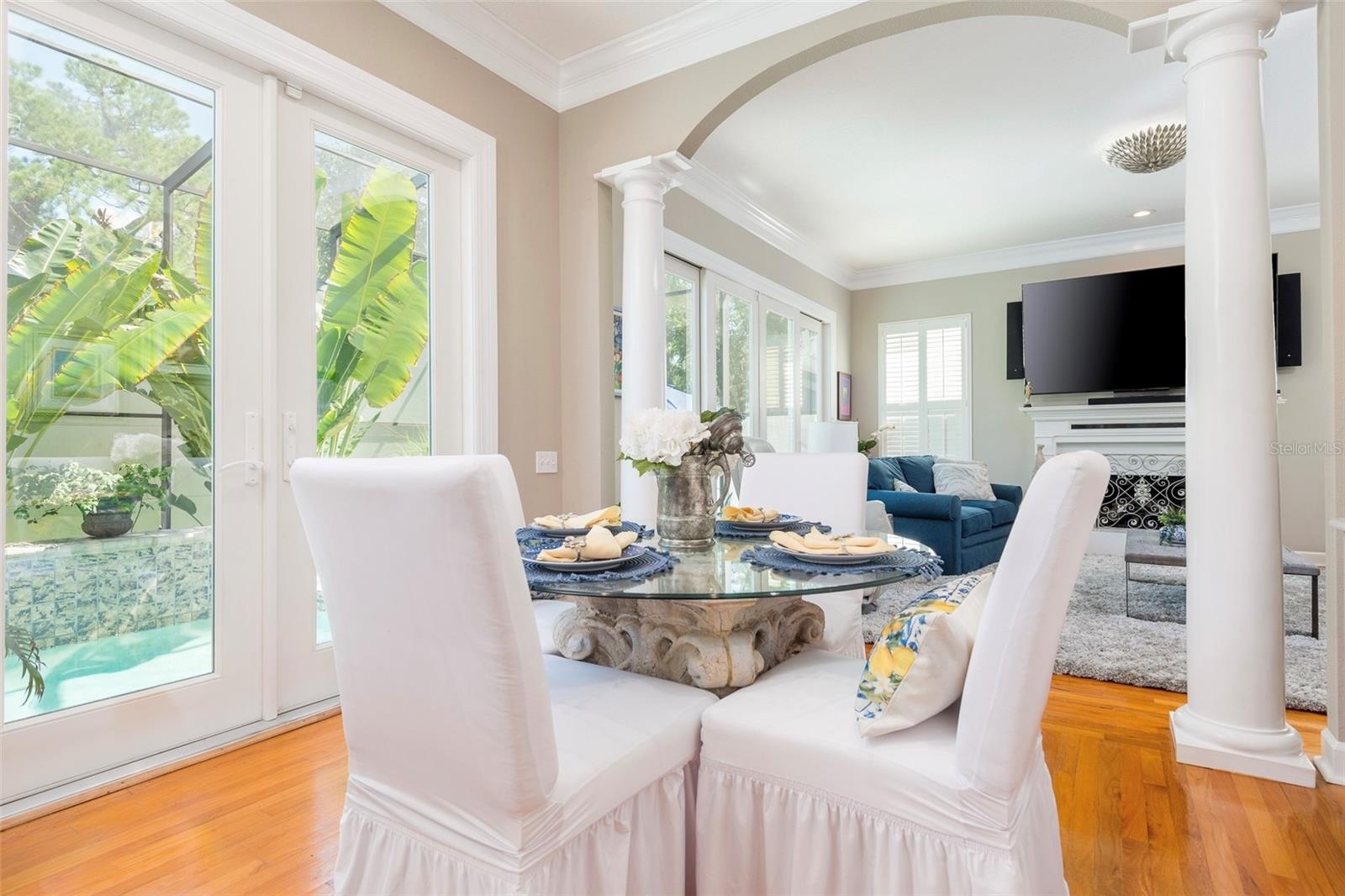 Breakfast area showing access to Living room French doors leading to pool
