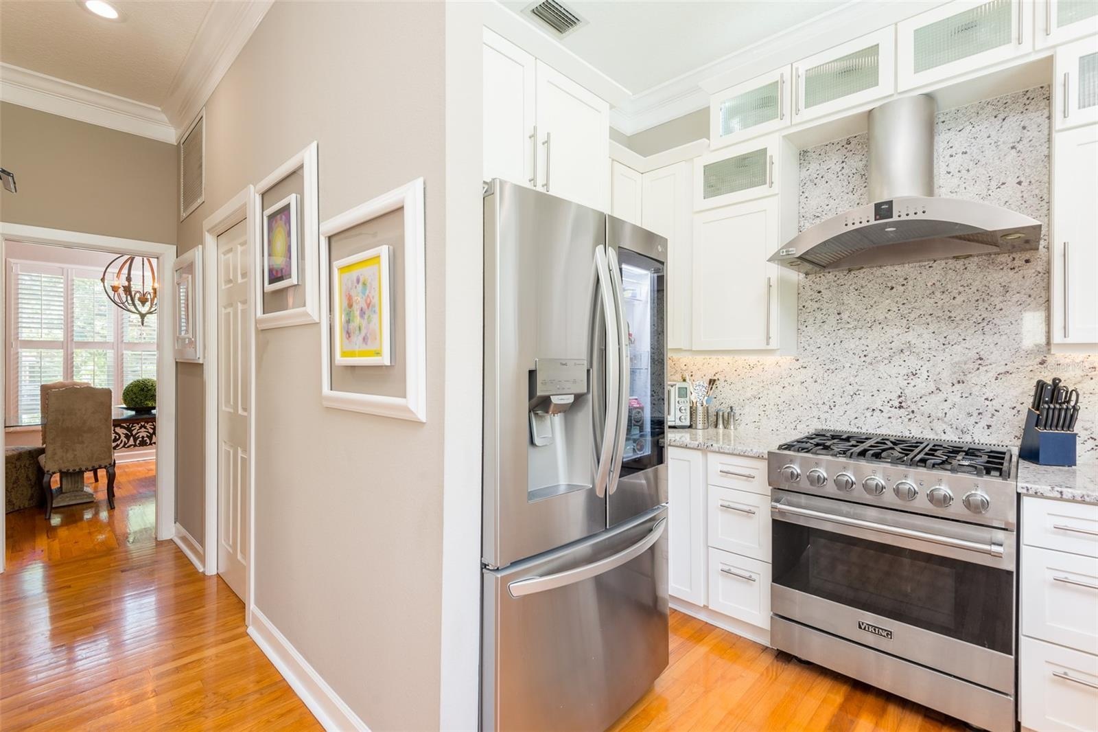 Kitchen view of LG Refrigerator with glass door and Viking Gas Range