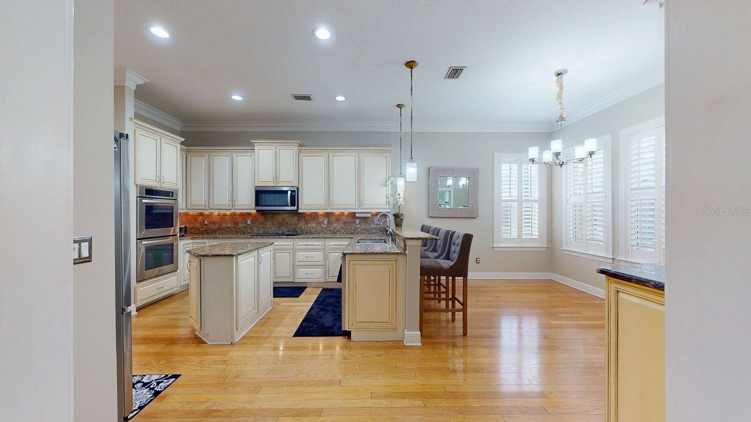 Side view of kitchen with incredible natural lighting and pool view