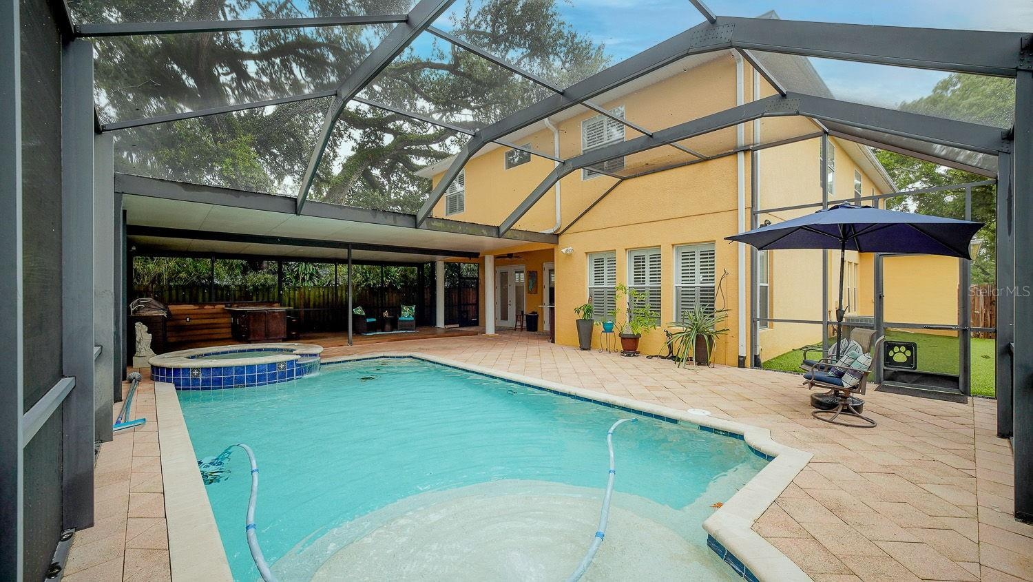Beautiful caged pool area with ciovered lanai