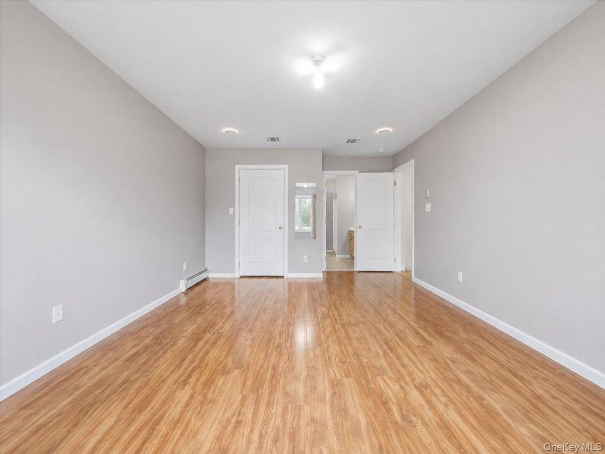 ANOTHER VIEW OF PRIMARY BEDROOM W/ VIEW OF BATH
