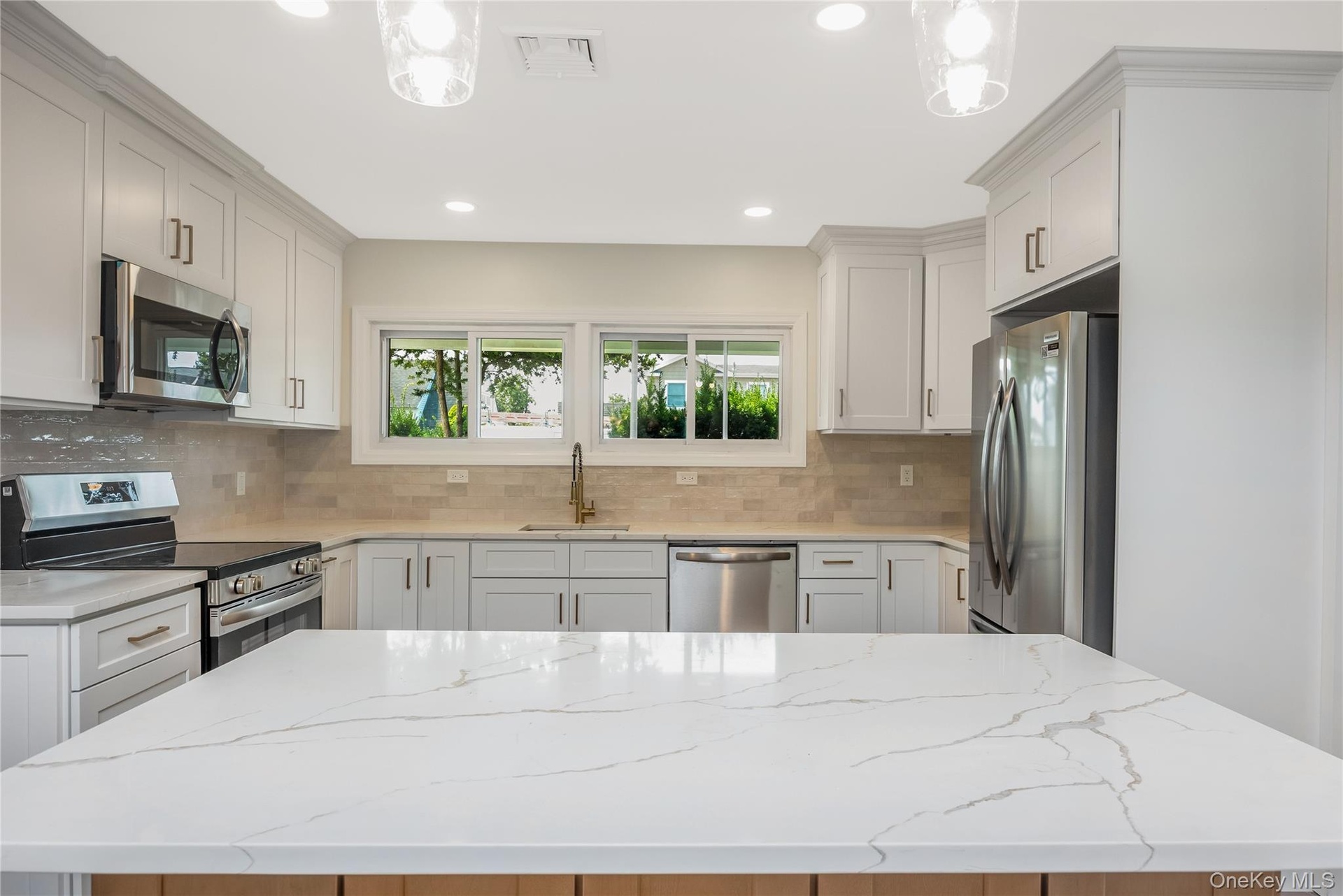View from Open area into kitchen  with island