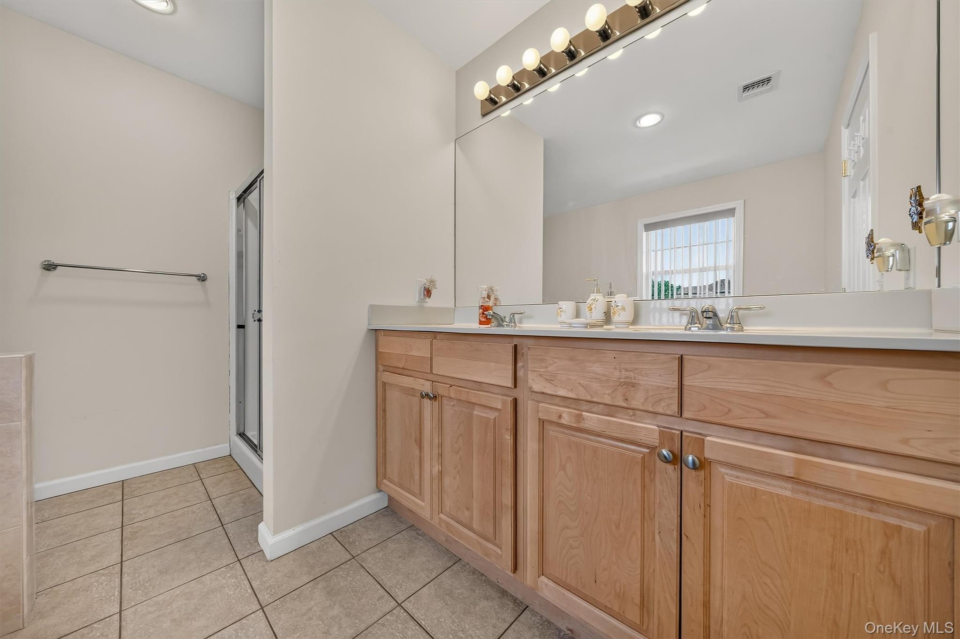 A wall of vanities, double sinks and cabinets!
