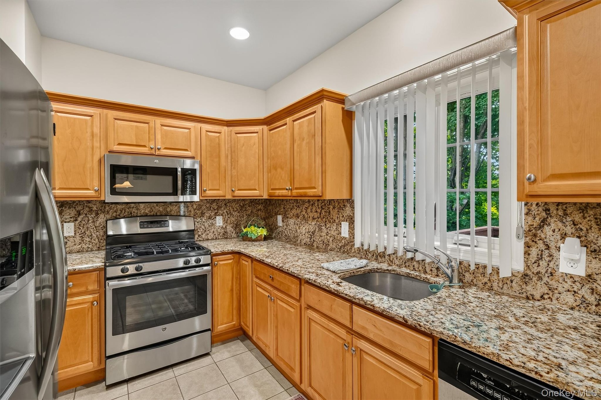 The kitchen has a large window above the sink overlooking the back yard.