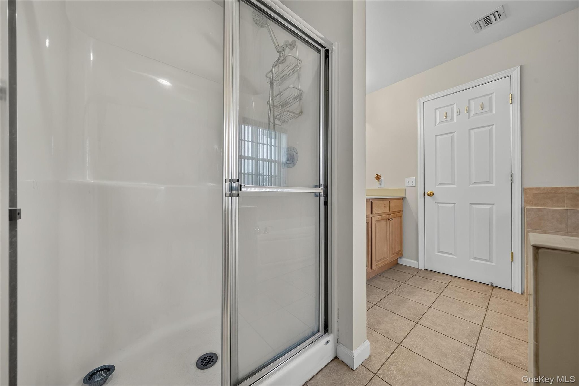 There is a separate shower in the primary bathroom.