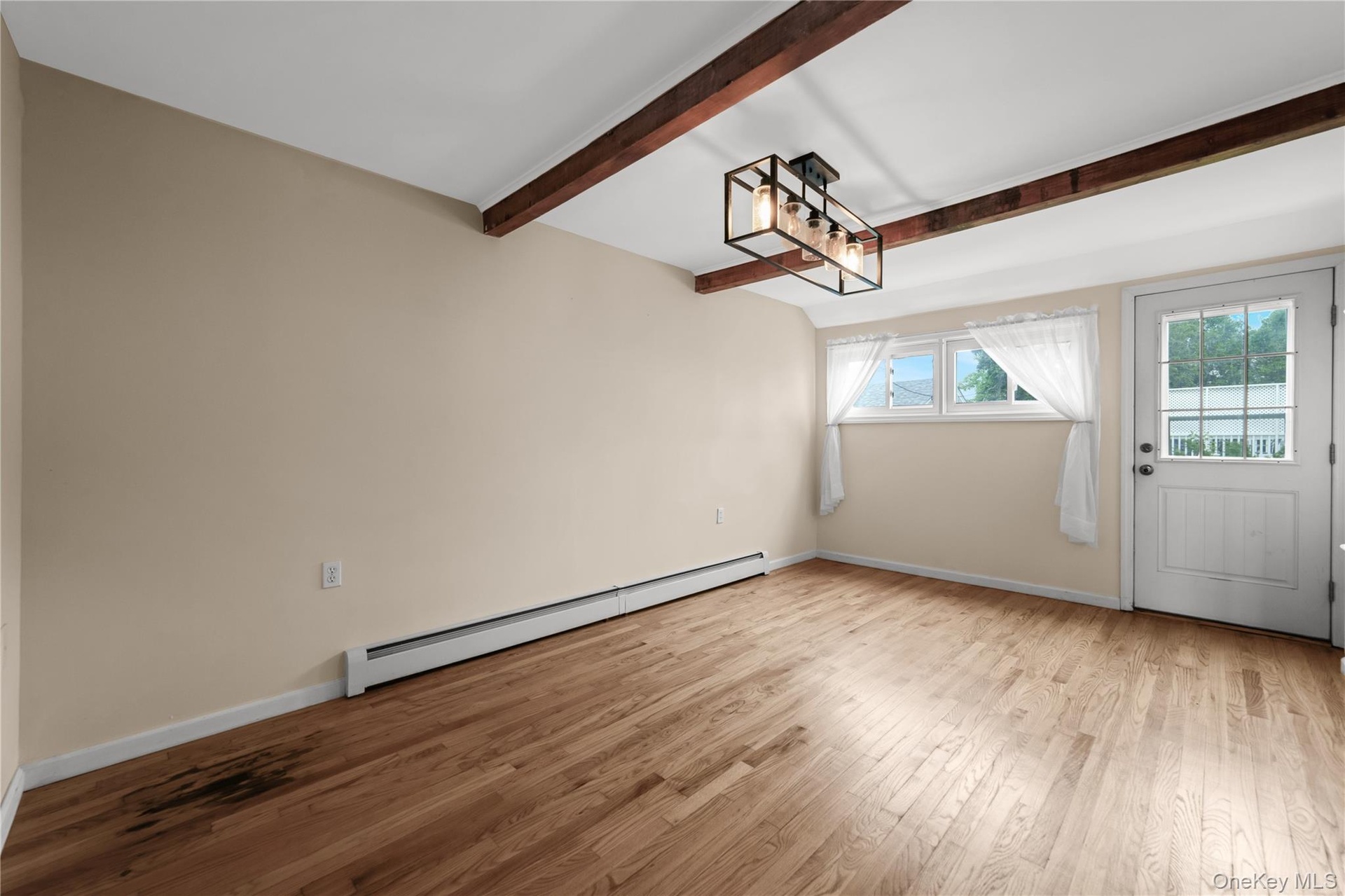 Large Bright Dining Room with Exposed Celilig Beams, Entrance to Backyard