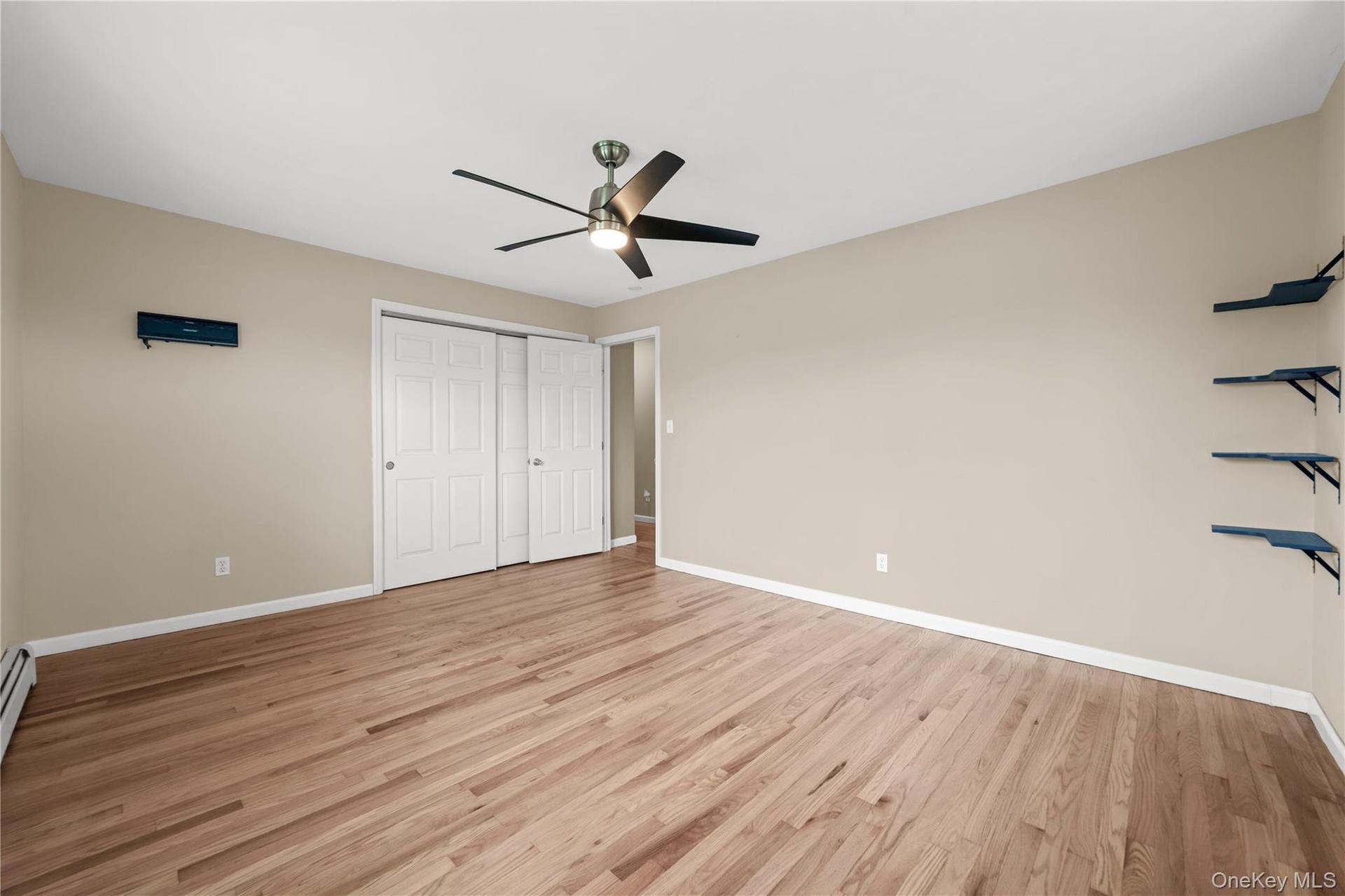 Another view of the Primary bedroom with hardwood flooring