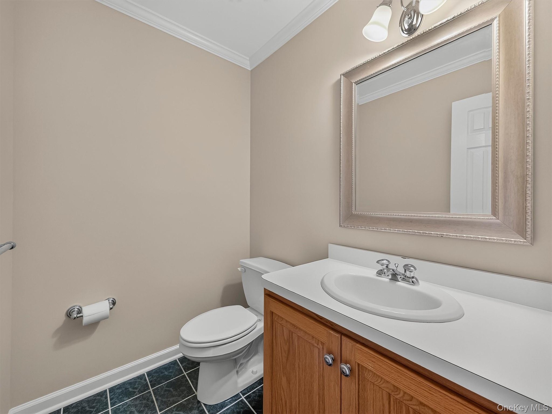 A conveniently located main-level powder room provides added comfort for both everyday living and guests.