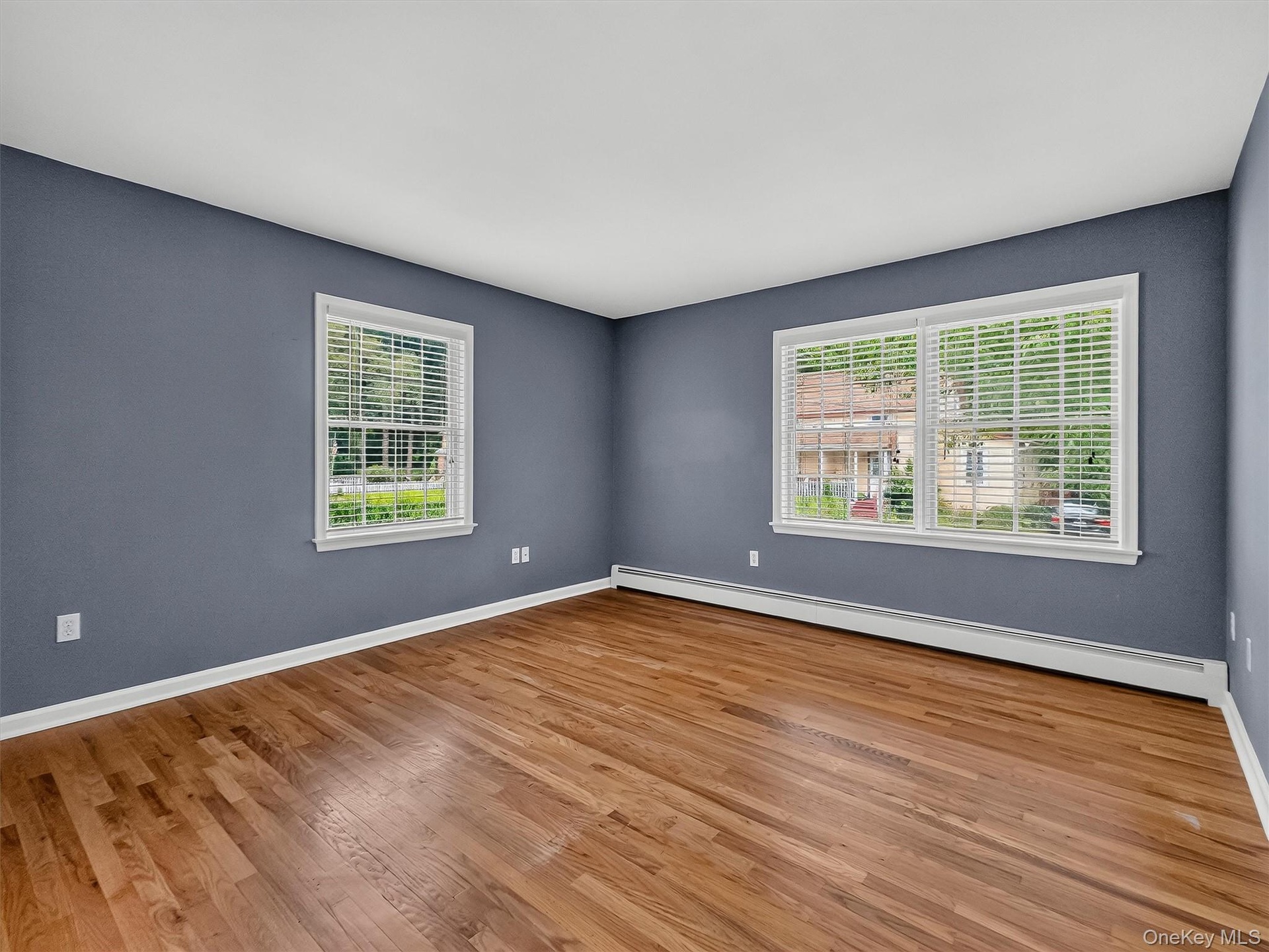 Bright and generously proportioned, this spacious bedroom features beautiful hardwood floors and natural light from two exposures.