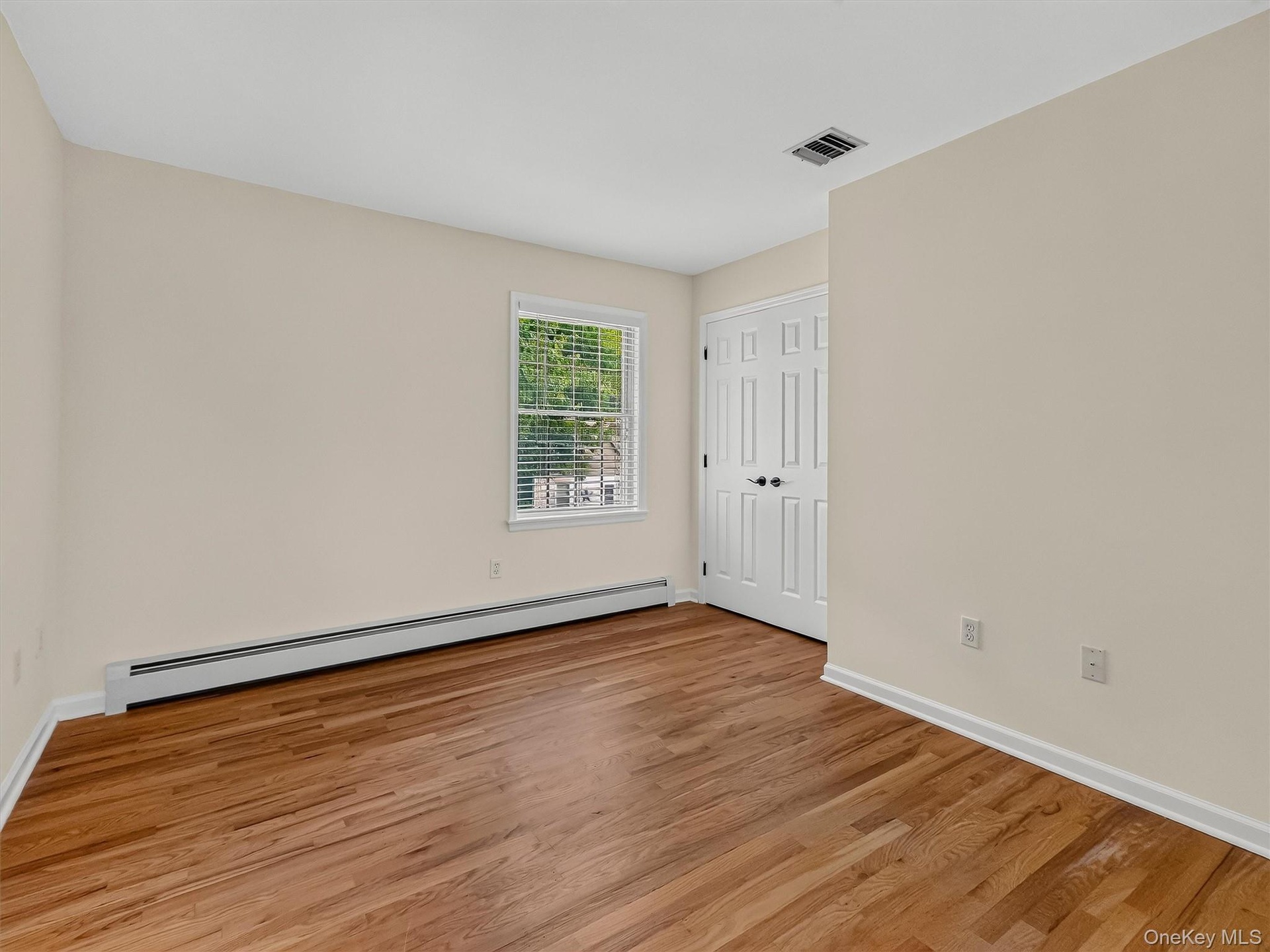 Another generously sized bedroom offers beautiful hardwood floors, natural light and plenty of room for comfortable everyday living.