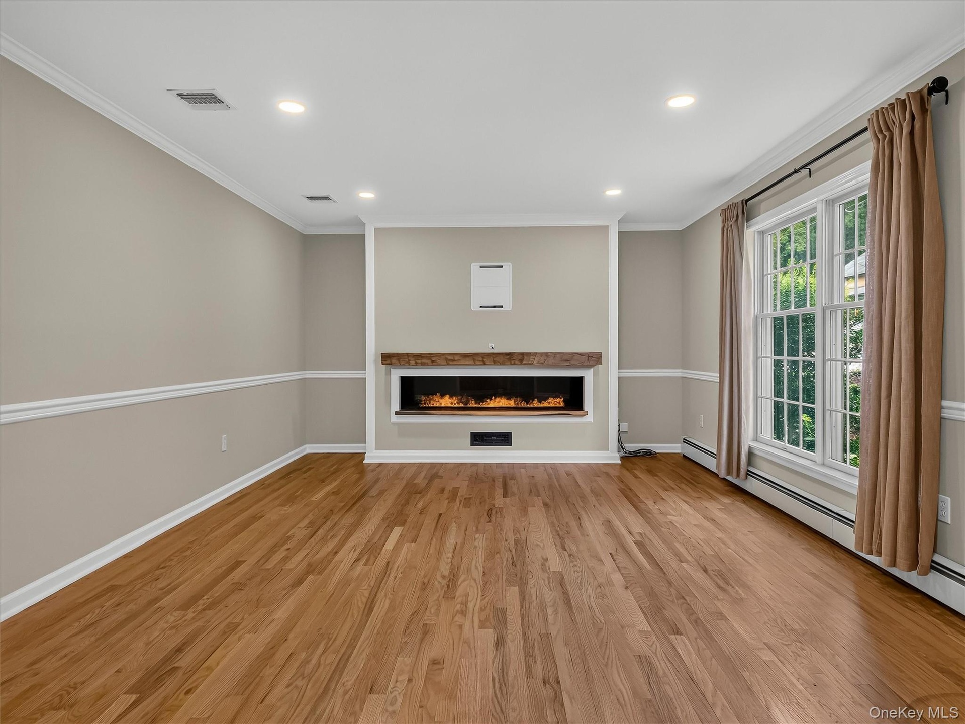 Designed for both comfort and style, the expansive living area features elegant architectural details, recessed lighting, and a striking custom center