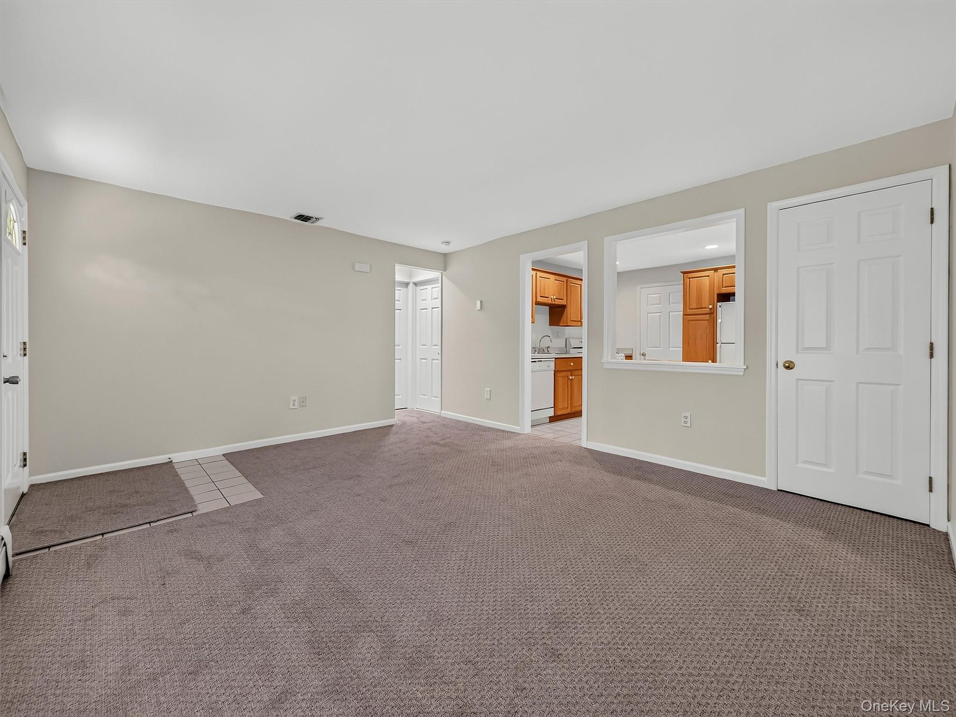 Generous living space flows directly to the summer kitchen, creating a comfortable and highly functional lower level with room to relax, gather and en