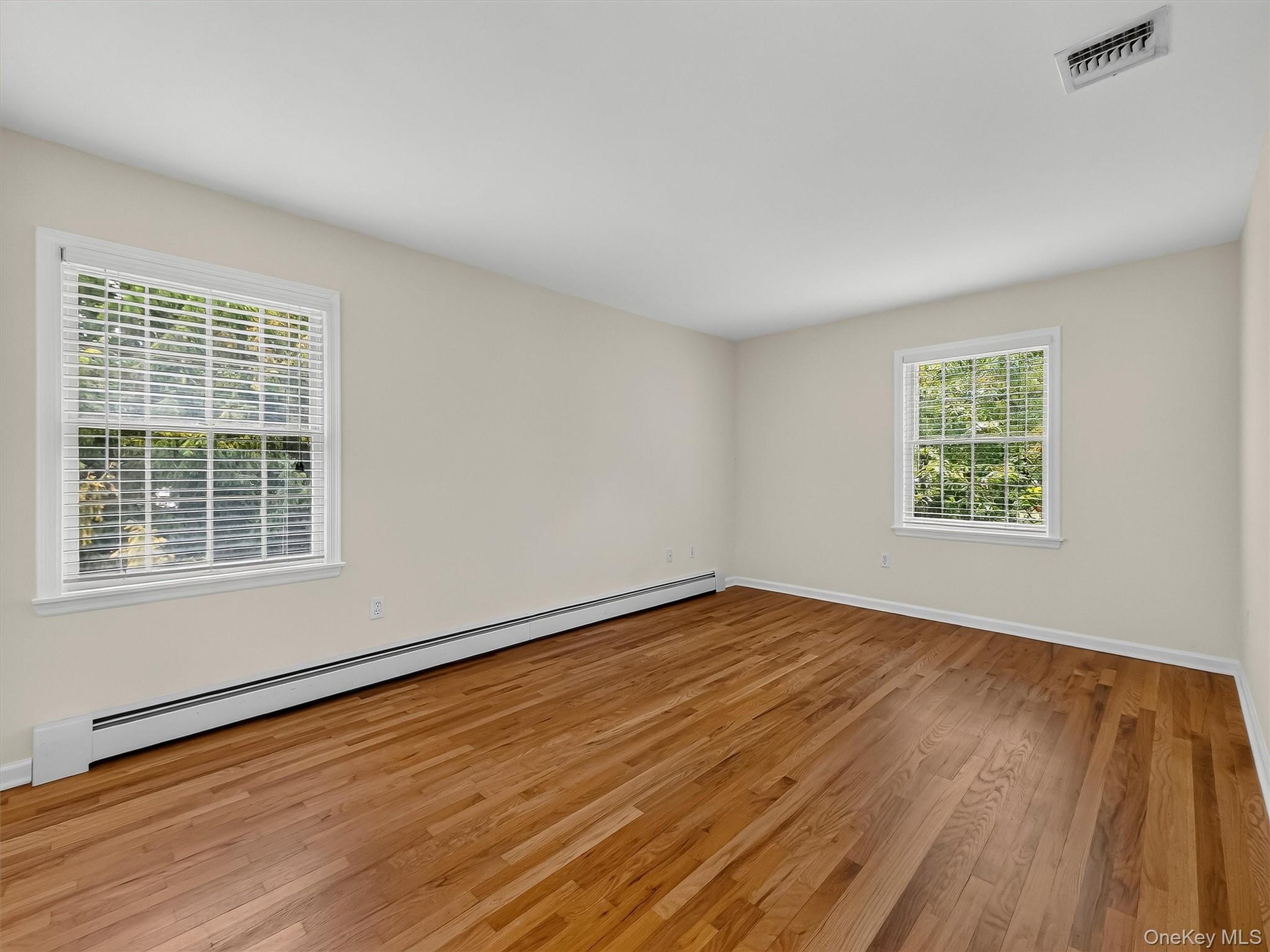 Generous proportions continue in the third bedroom, with hardwood floors and natural light from two exposures creating a bright, comfortable retreat.