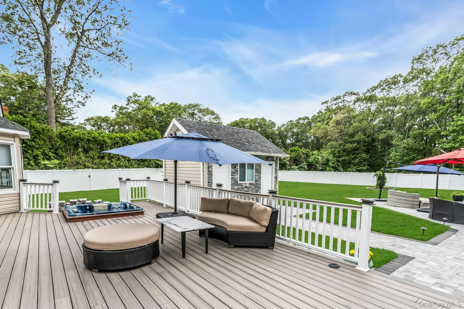 Deck featuring an outdoor living space, view of scattered trees, and an outbuilding