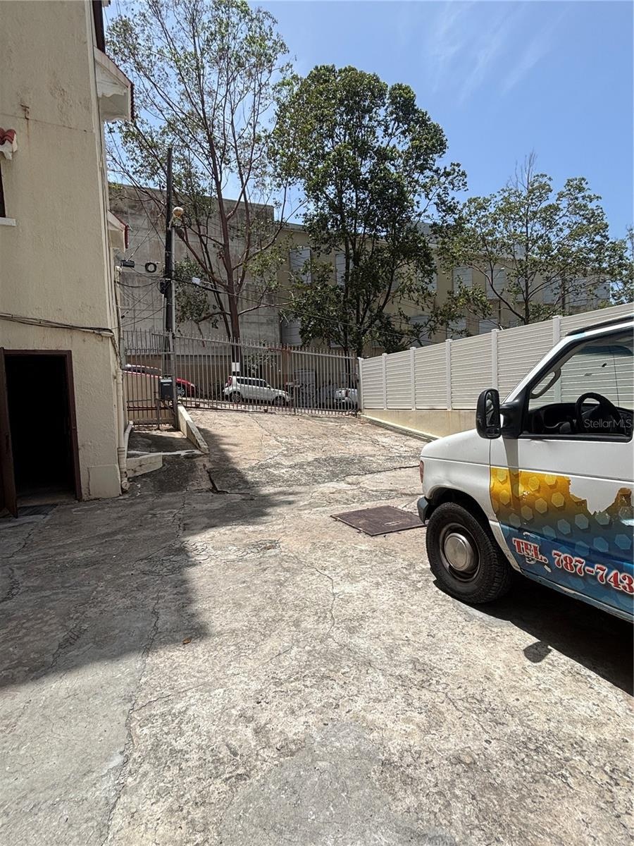The rear parking/loading area has secure gated access from Calle Cerra. The puerto Rico Conservatory of Music is in the background.  The door at the l