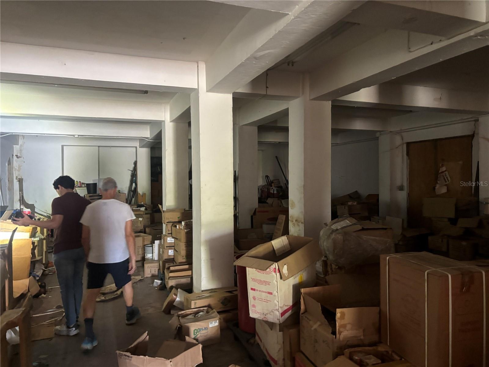 Warehouse level has doors to the lobby staircase and an exterior door the courtyard terrace and another exterior door to the lower garage level.