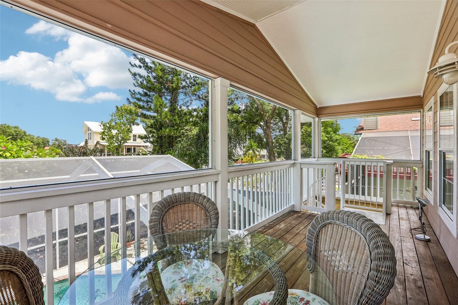 Second floor screened patio and stairs to the pool area
