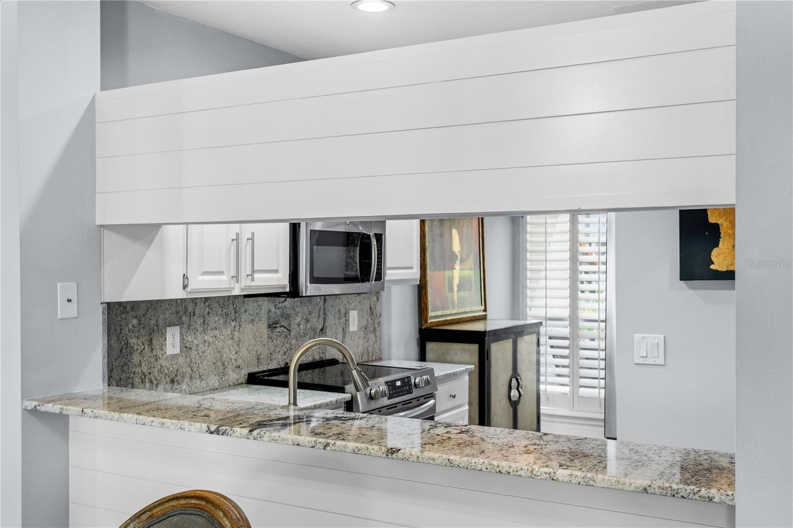 The kitchen pass-through offers the perfect spot for a buffet, making entertaining effortless.