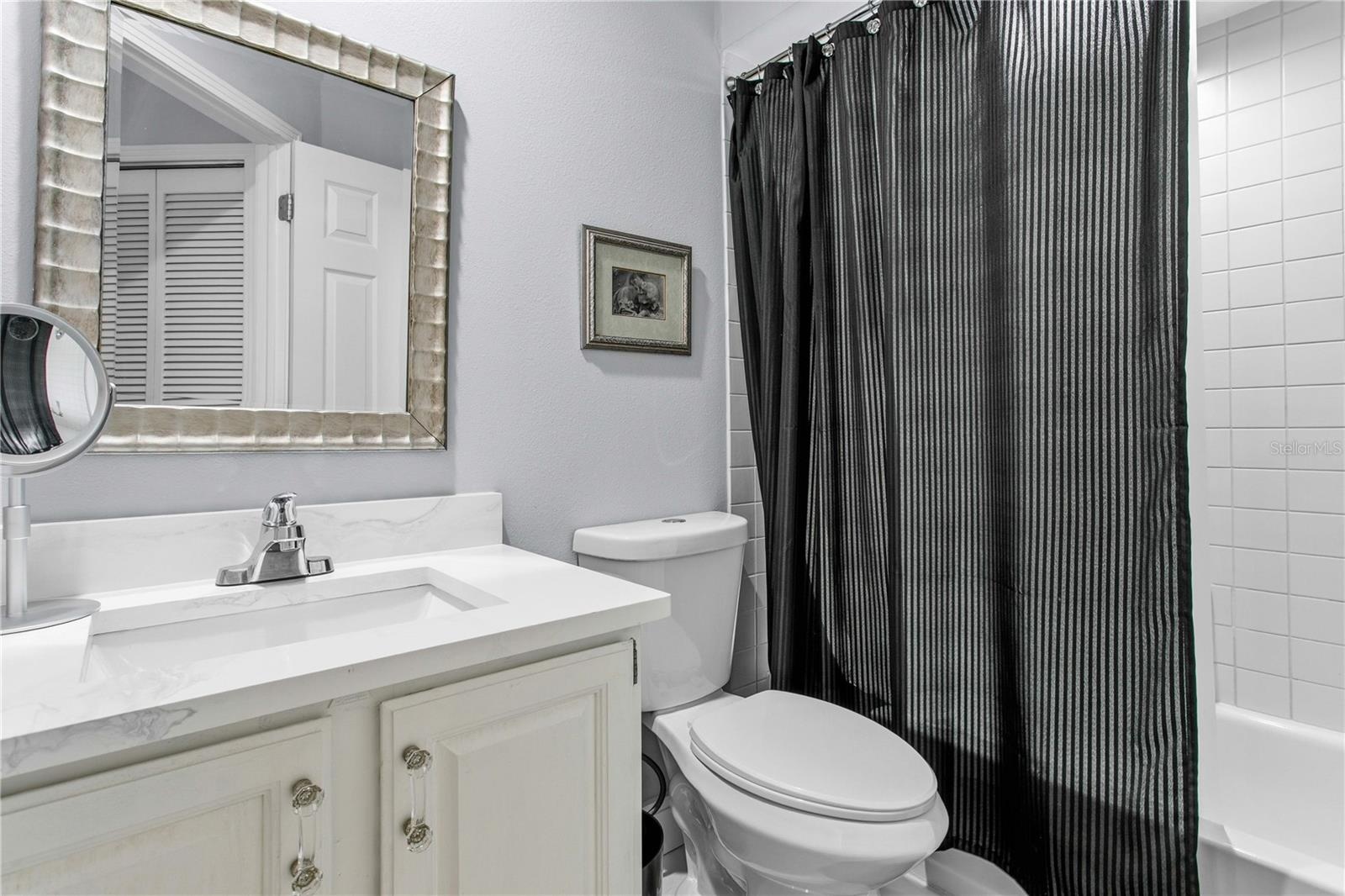 The en-suite bath is neatly designed for comfort, privacy, and ease.