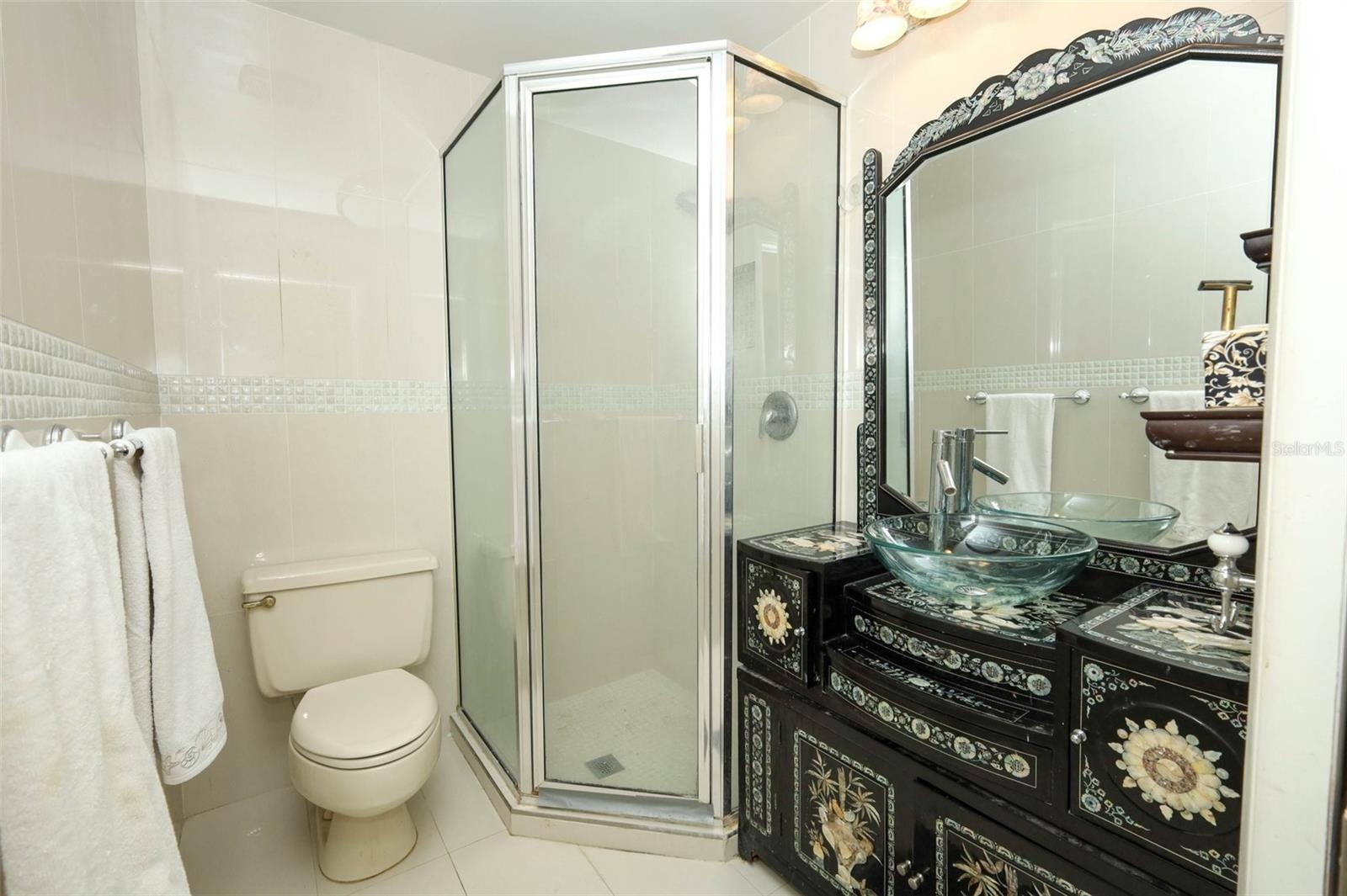 Secondary Bath with shower & custom vanity.