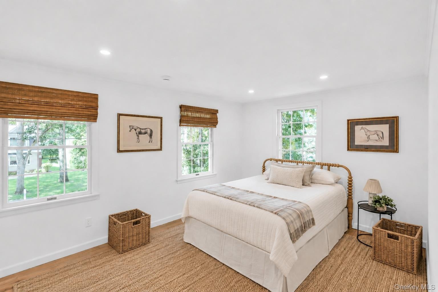 Recessed lighting, wood-finish flooring, and multiple double-hung windows with woven wood shades