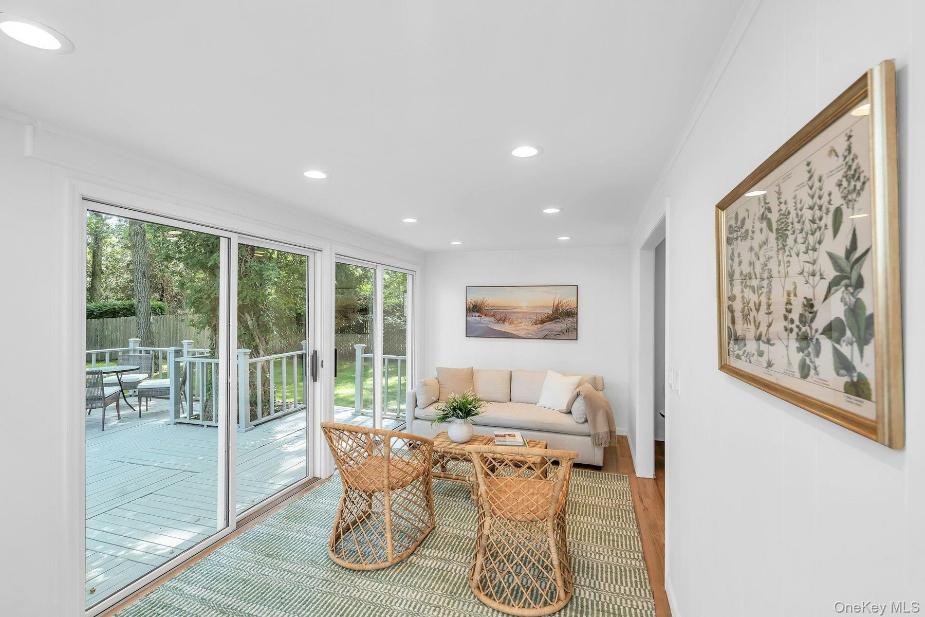 Sun room off kitchen, living room area, sliding doors to deck