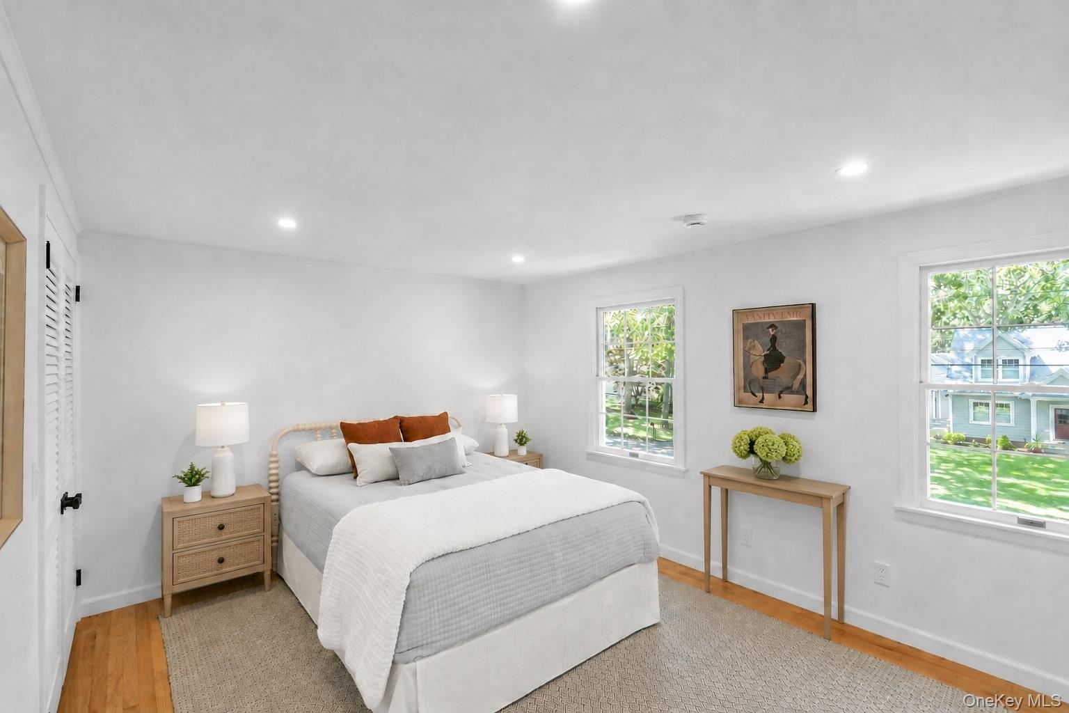 Recessed lighting, wood-finish flooring, and white walls