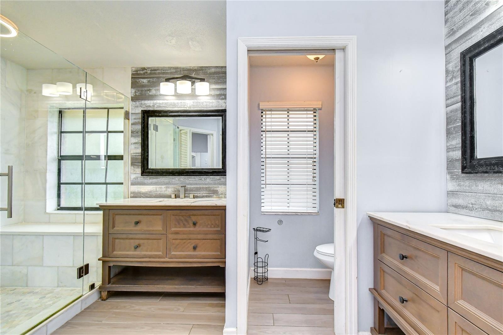 Features dual vanities and a beautiful seamless glass shower