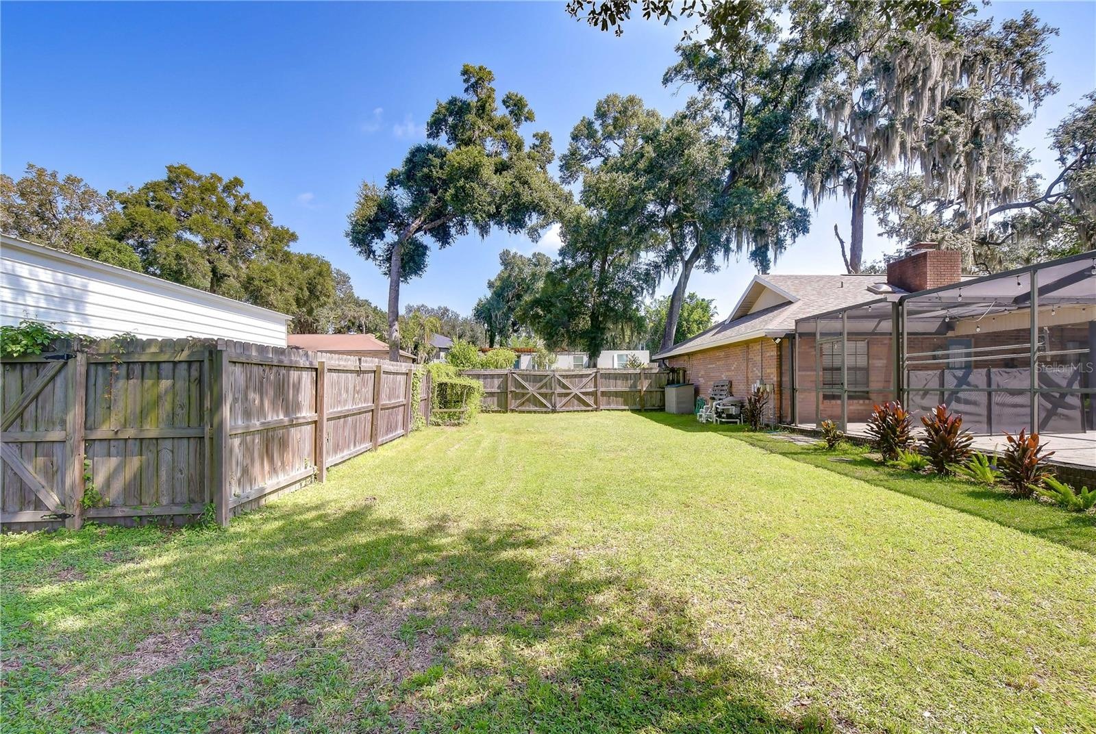 Oversized, lush backyard offers privacy and plenty of room for outdoor activities