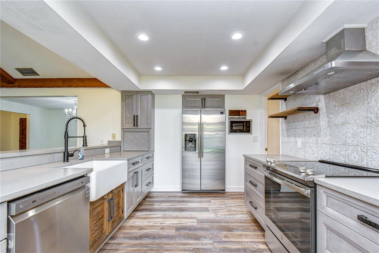 Open kitchen featuring stainless steel appliances, abundant cabinetry, and generous counter space